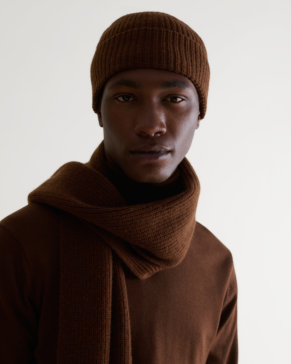Close up of man wearing Rise & Fall's burl brown cashmere merino ribbed scarf with matching coloured jumper and beanie