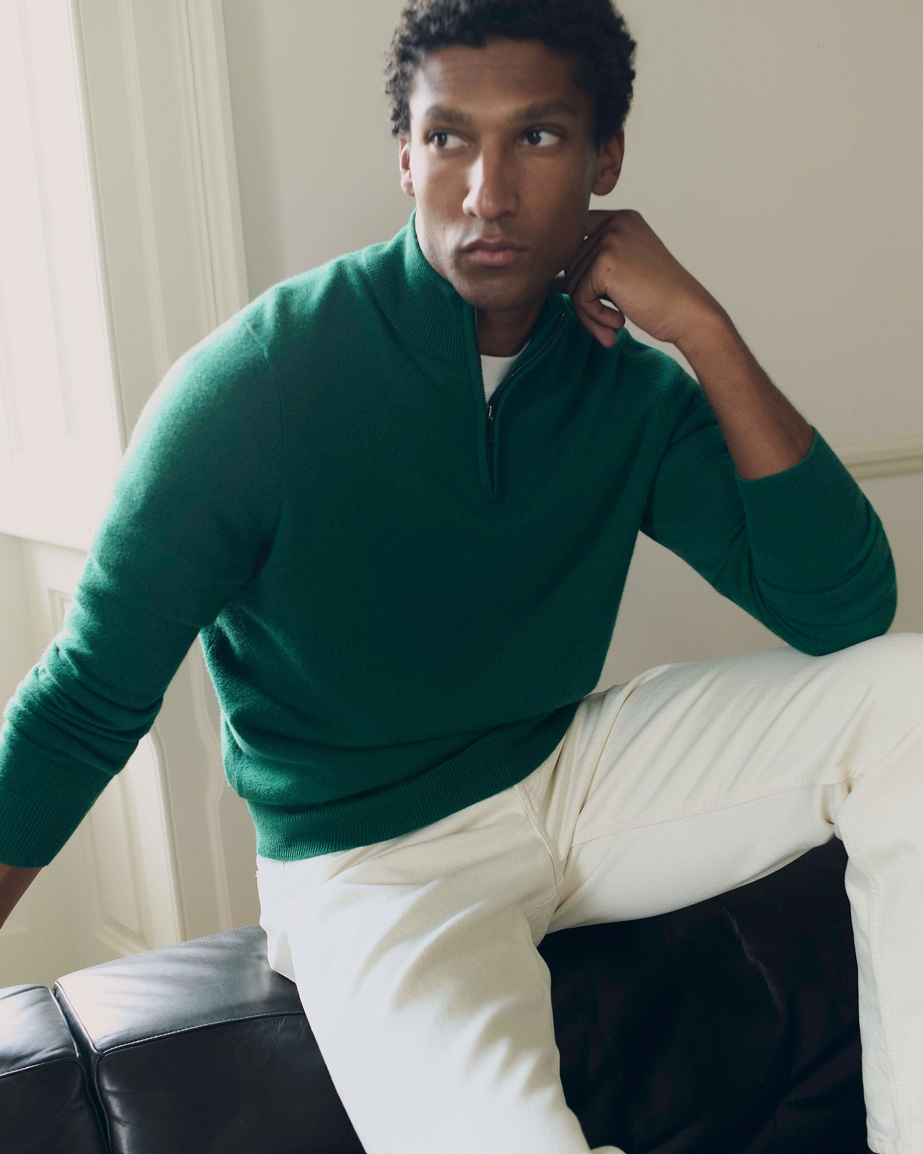 Man wears green Quarter Zip Cashmere Jumper With White T-shirt and Jeans.