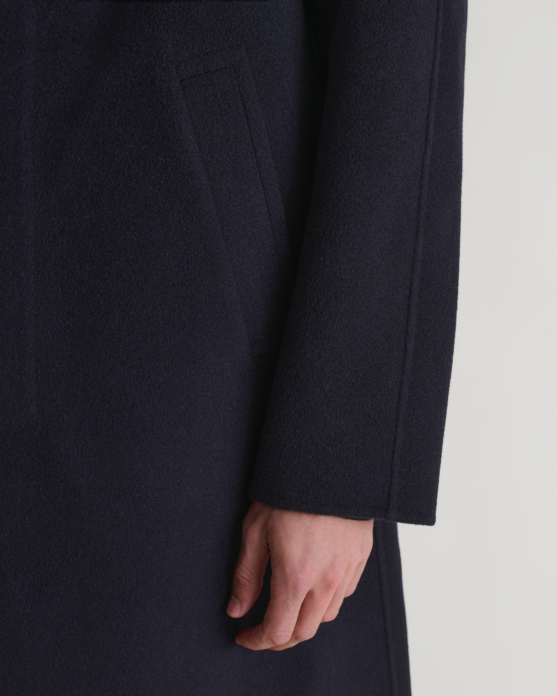 Rise & Fall's navy cashmere merino wool double-faced coat. Close up of sleeve.