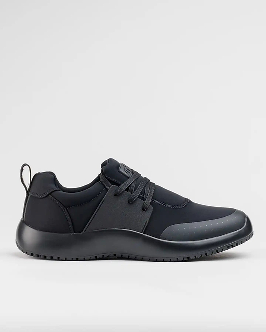 A pair of black slip-on sneakers with an adjustable lace option, made from recycled materials, vegan friendly, and designed for comfort and slip resistance.
