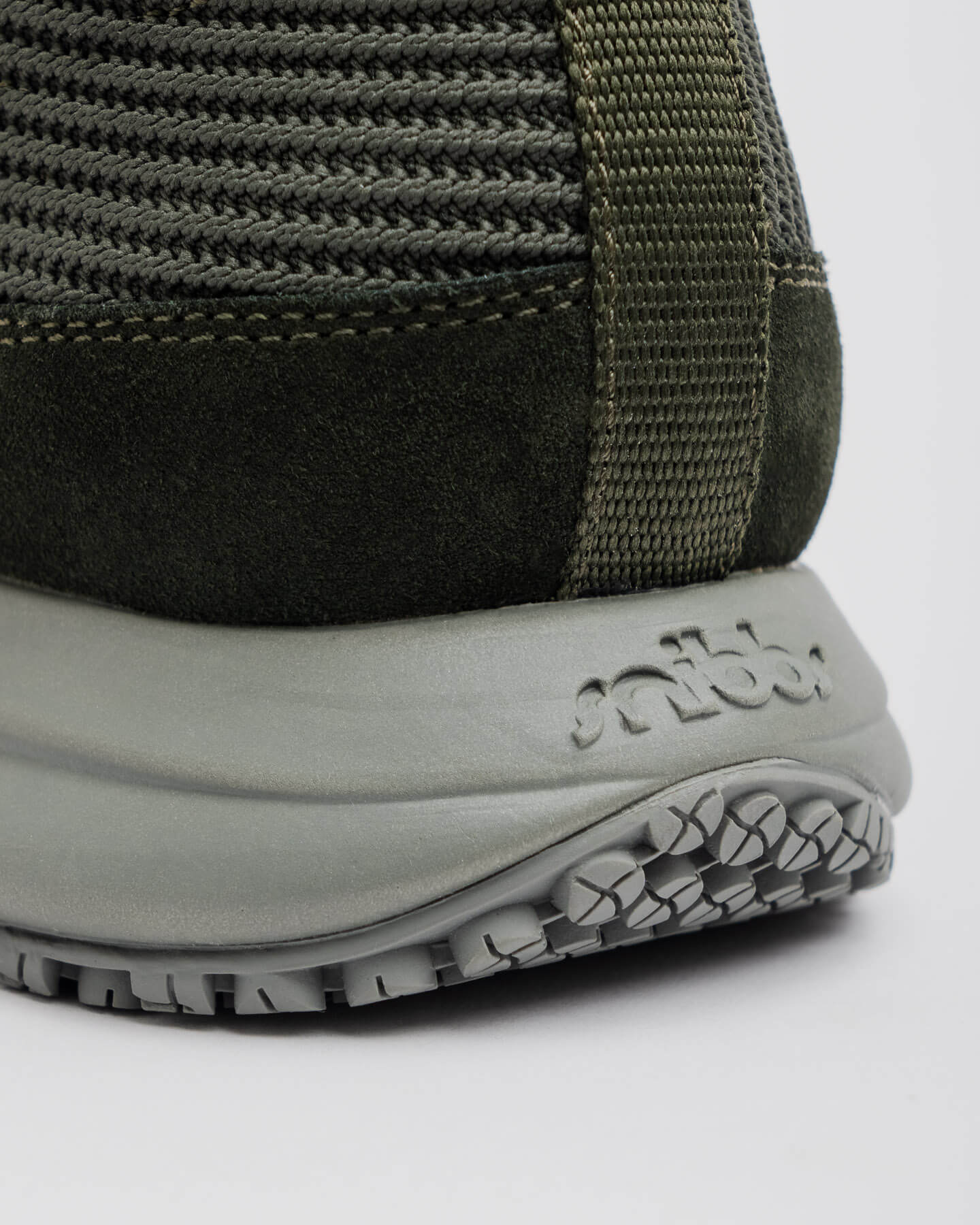 Close-up of the heel of the Snibbs ROVR Mid - Climbing Ivy with a textured gray sole and ribbed mesh upper.
