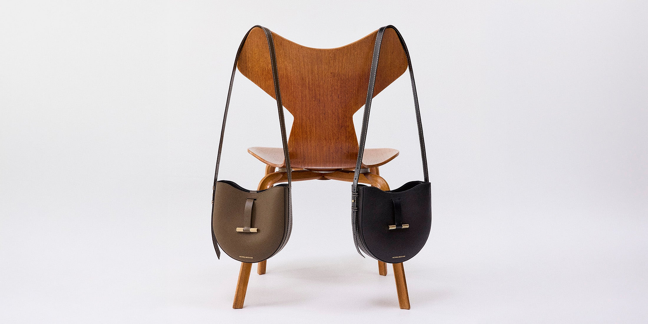 A chair with a bag resting on its seat, showcasing a simple indoor setting.