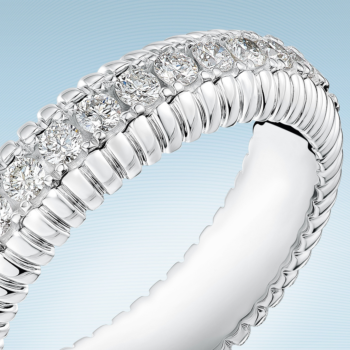 Close-up of a white gold diamond eternity ring from the Love Collection, showcasing brilliant-cut diamonds and timeless fine jewellery craftsmanship.