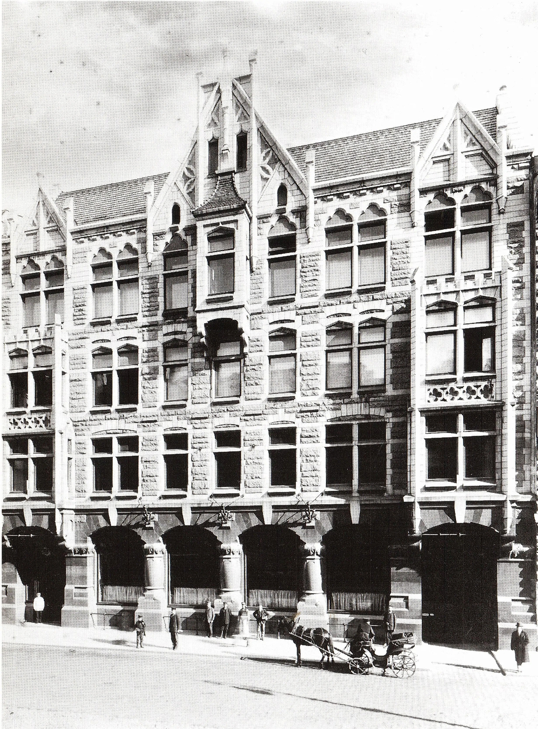 Vintage black and white photograph of a tall building with decorative architecture.