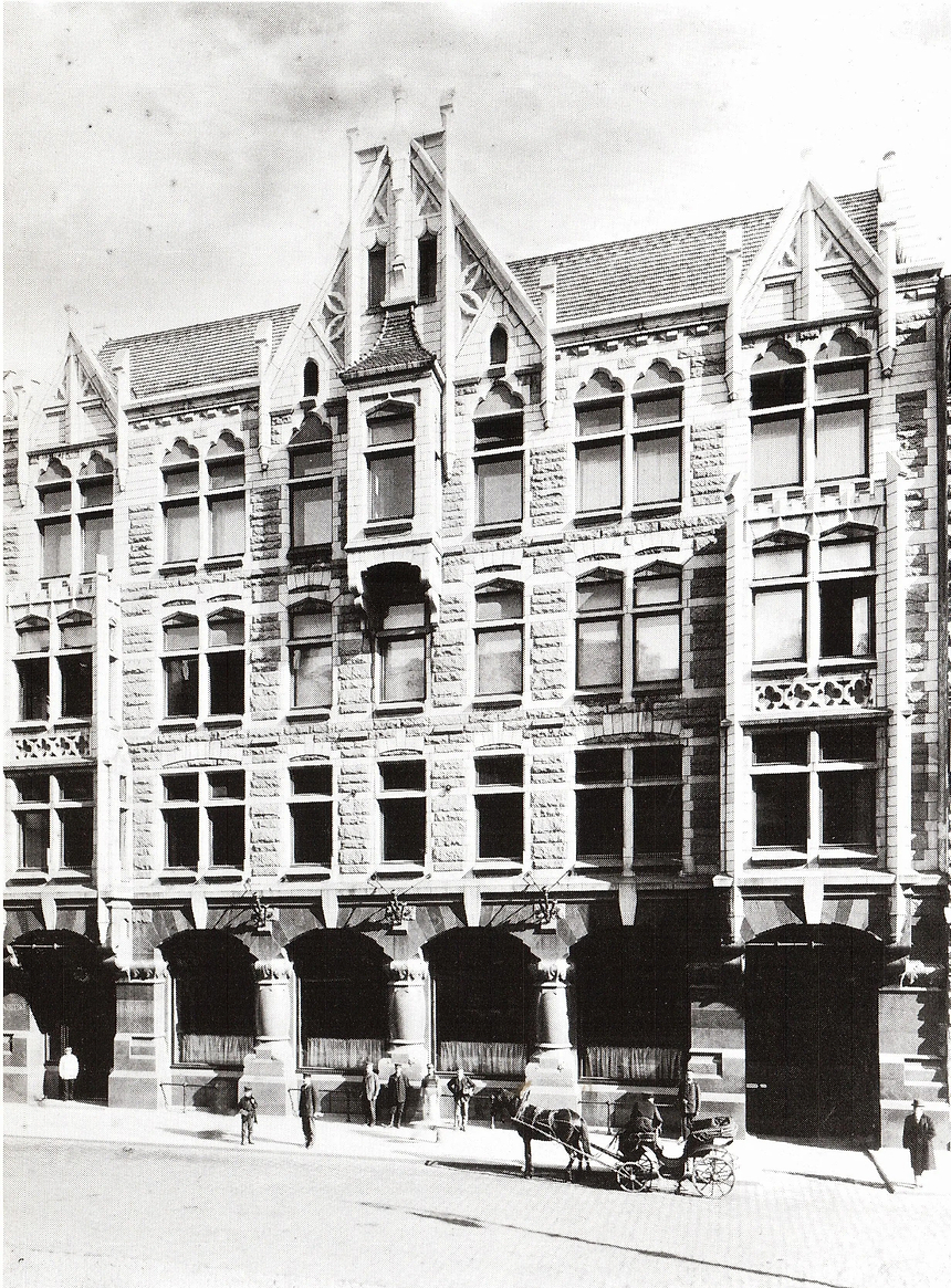 Vintage black and white photograph of a tall building with decorative architecture.
