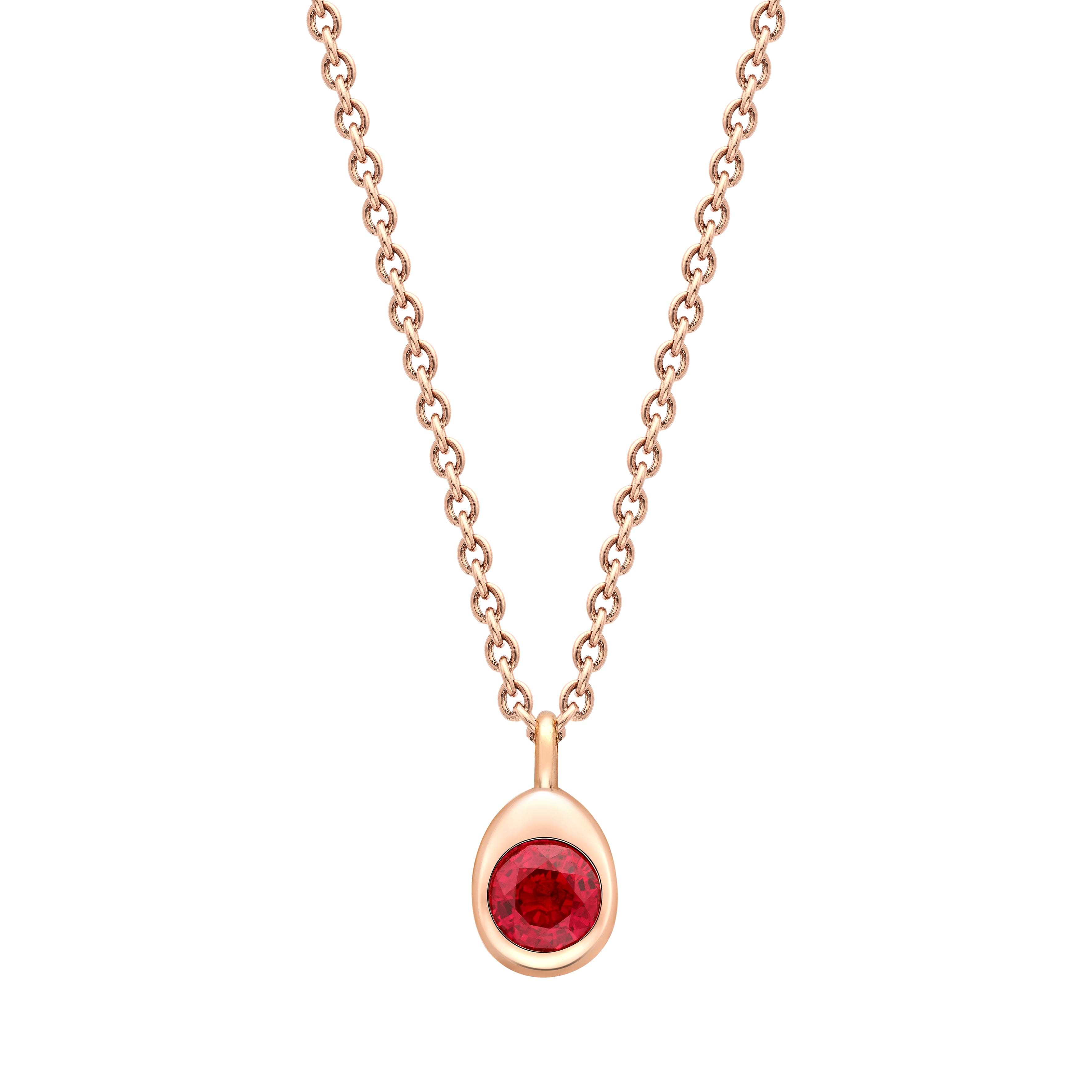 Fabergé gold and ruby necklace on a white background