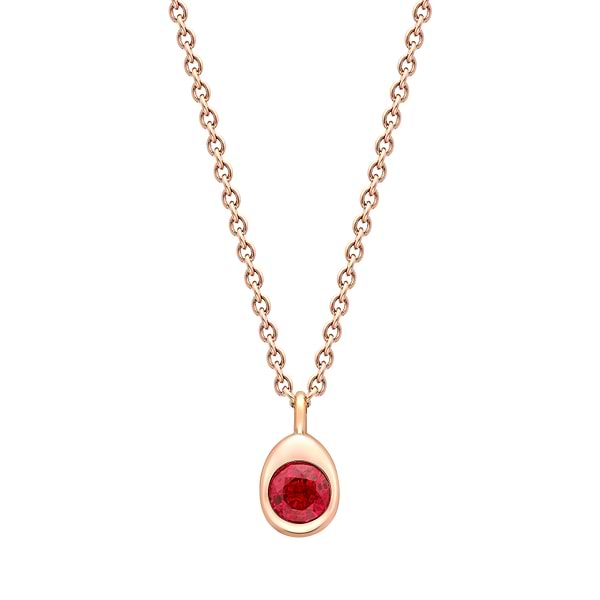 Fabergé gold and ruby necklace on a white background