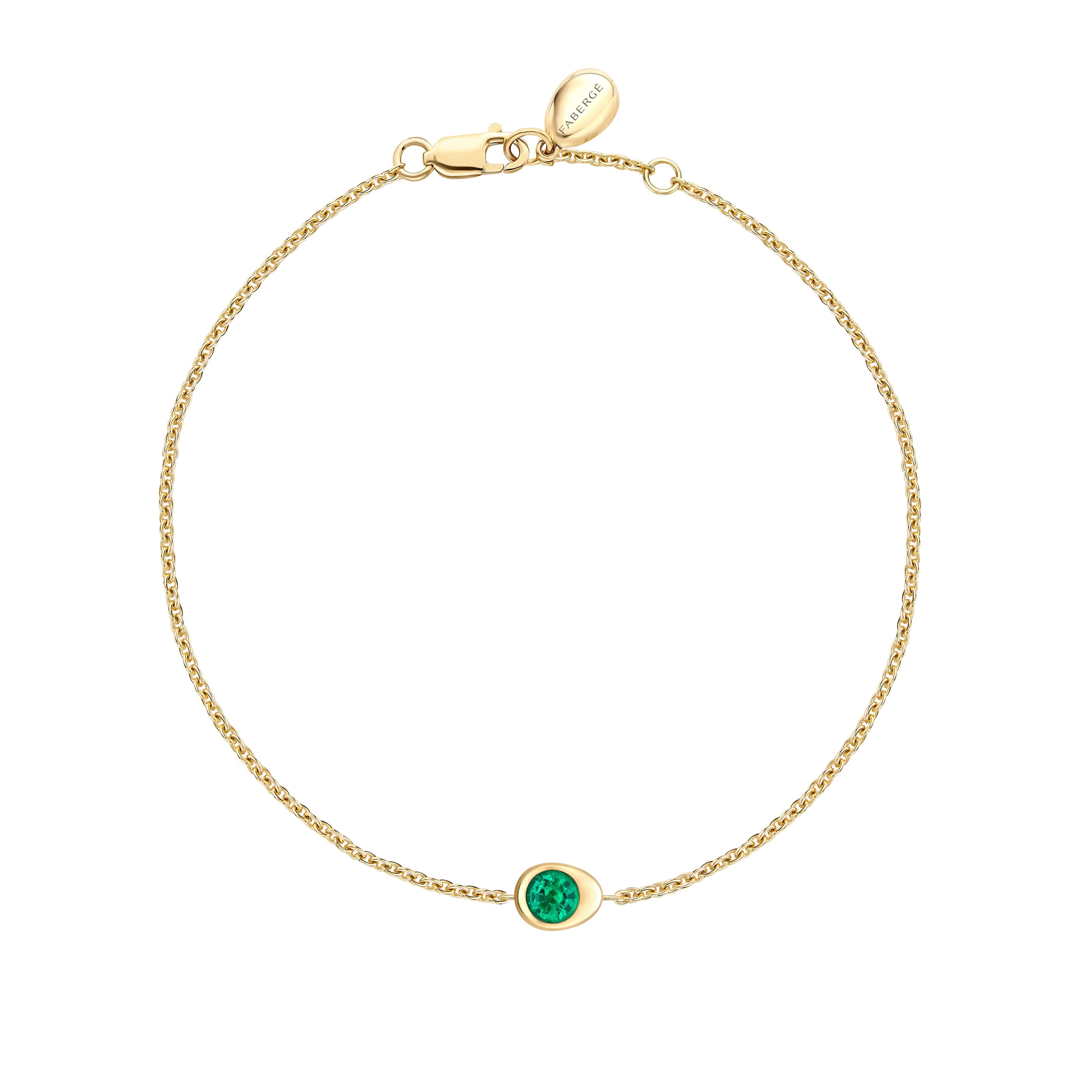 Fabergé gold and emerald bracelet on a white background