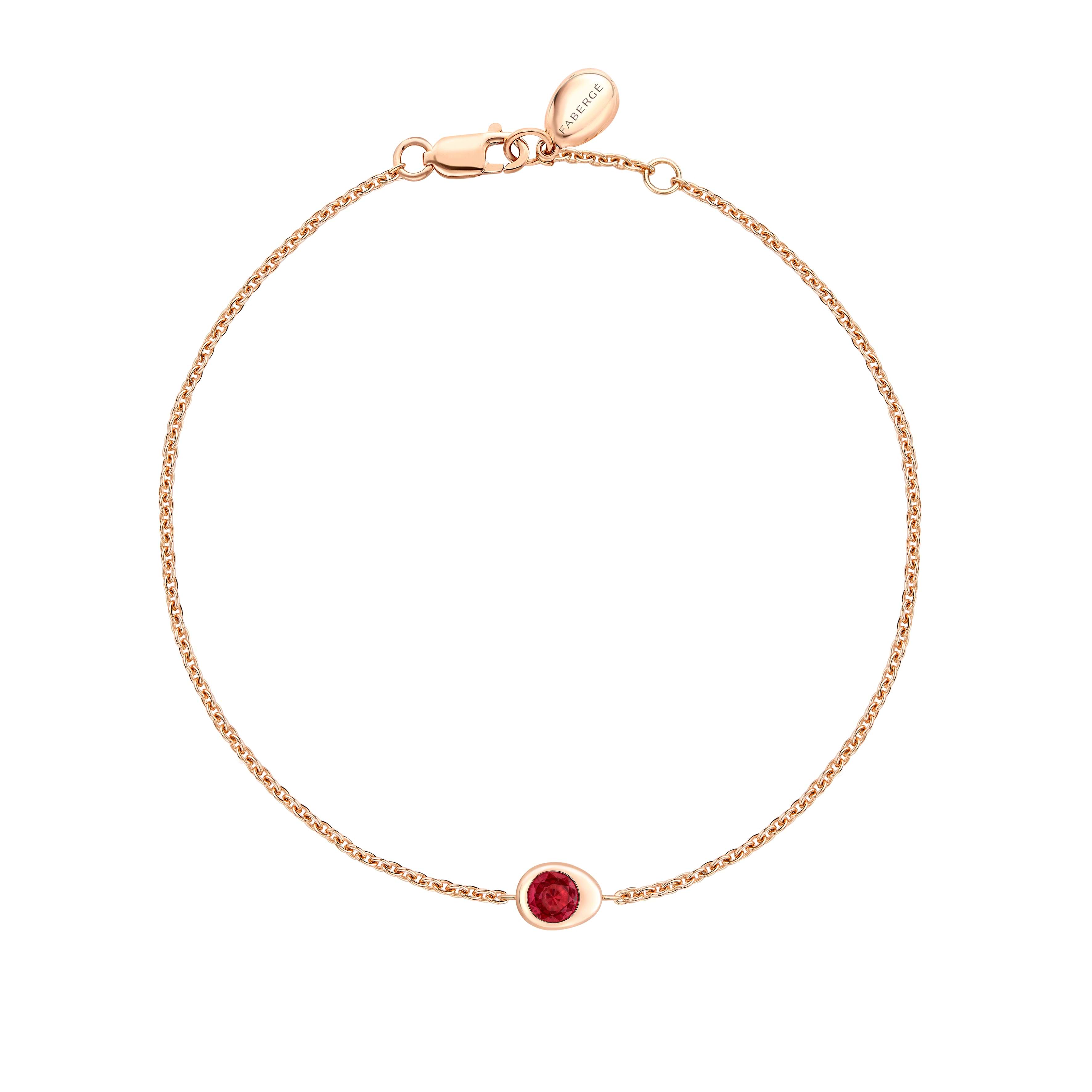 Fabergé gold and ruby bracelet on a white background