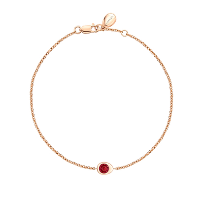 Fabergé gold and ruby bracelet on a white background