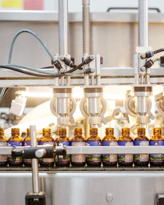 Amber tincture bottles moving through the WishGarden bottling line in Louisville, Colorado