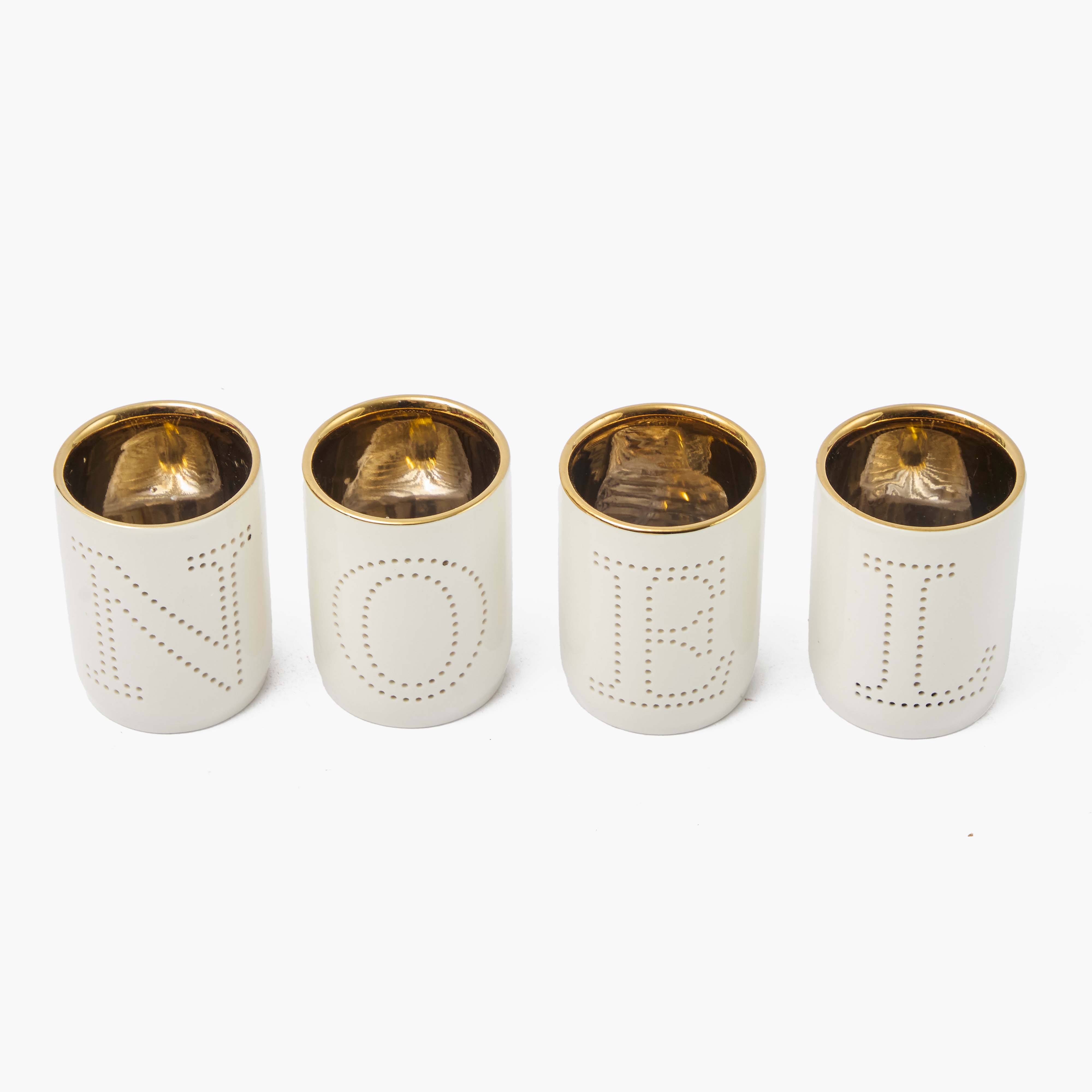 Four white cylindrical containers with gold tops on a white background