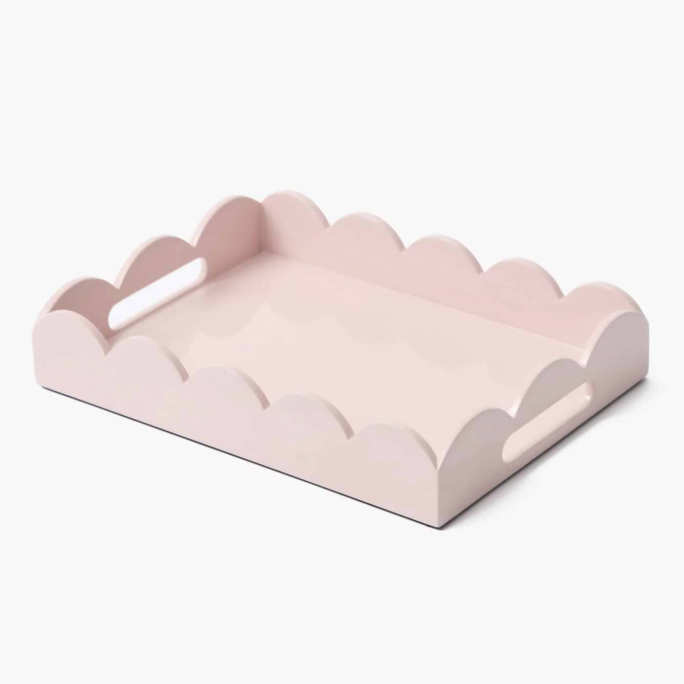 Pink scalloped-edge tray on a white background