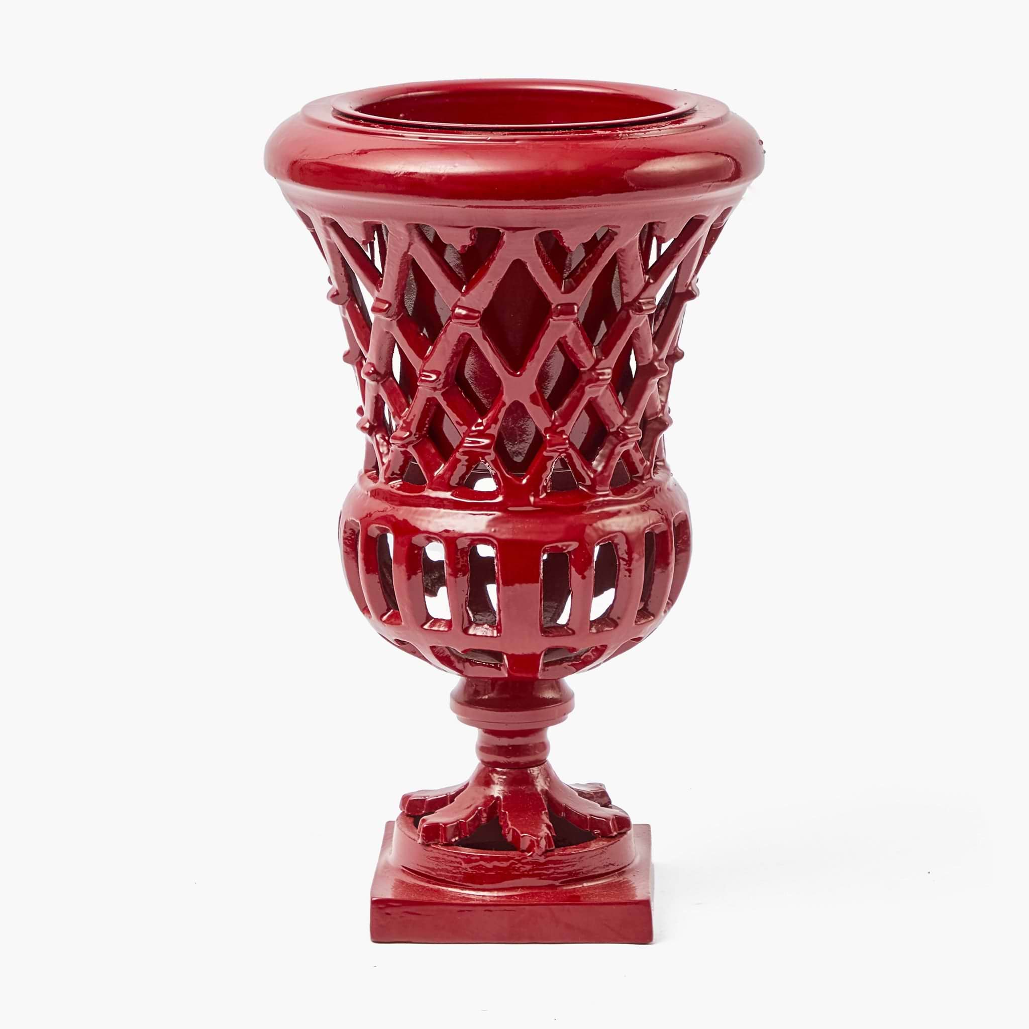 Red decorative urn with intricate lattice design on a white background