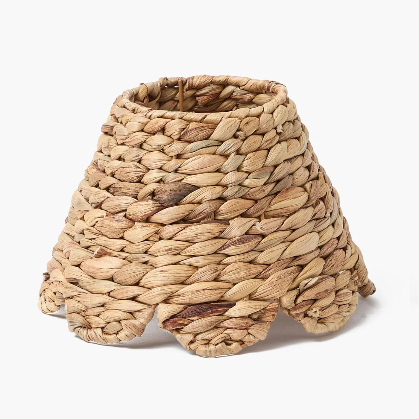 A beige natural seagrass lampshade with a conical shape and open weaved design.