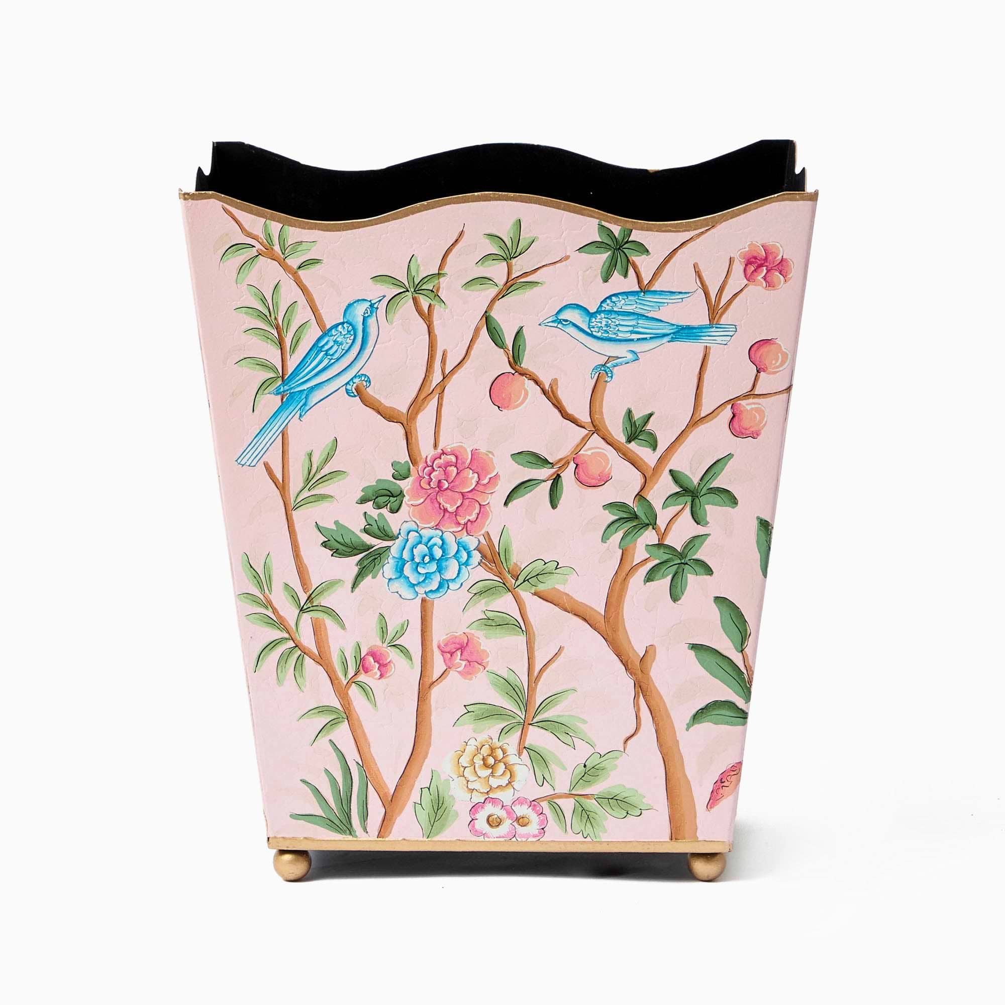 A decorative waste basket with a pink background, featuring floral patterns and blue birds.