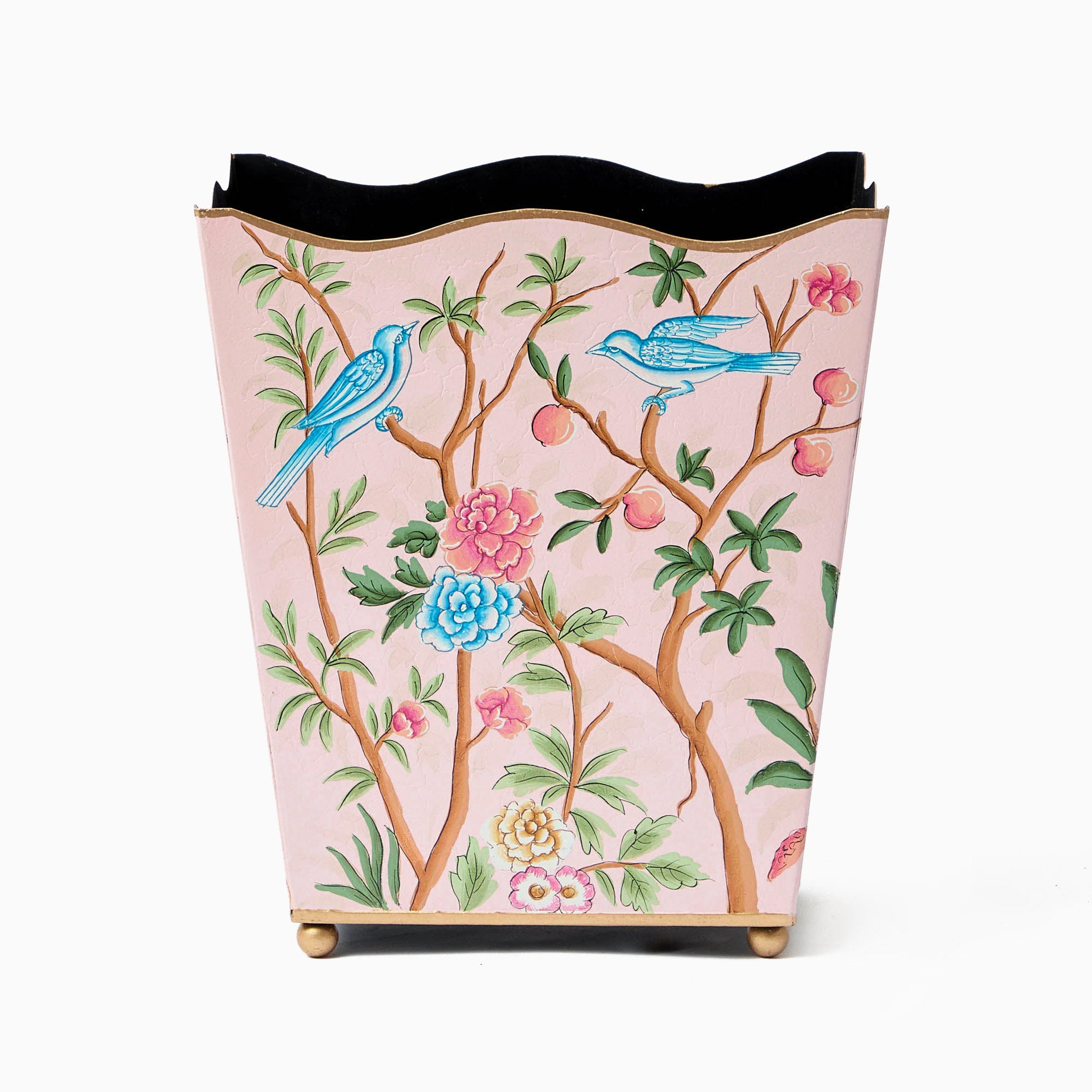 A decorative waste basket with a pink background, featuring floral patterns and blue birds.