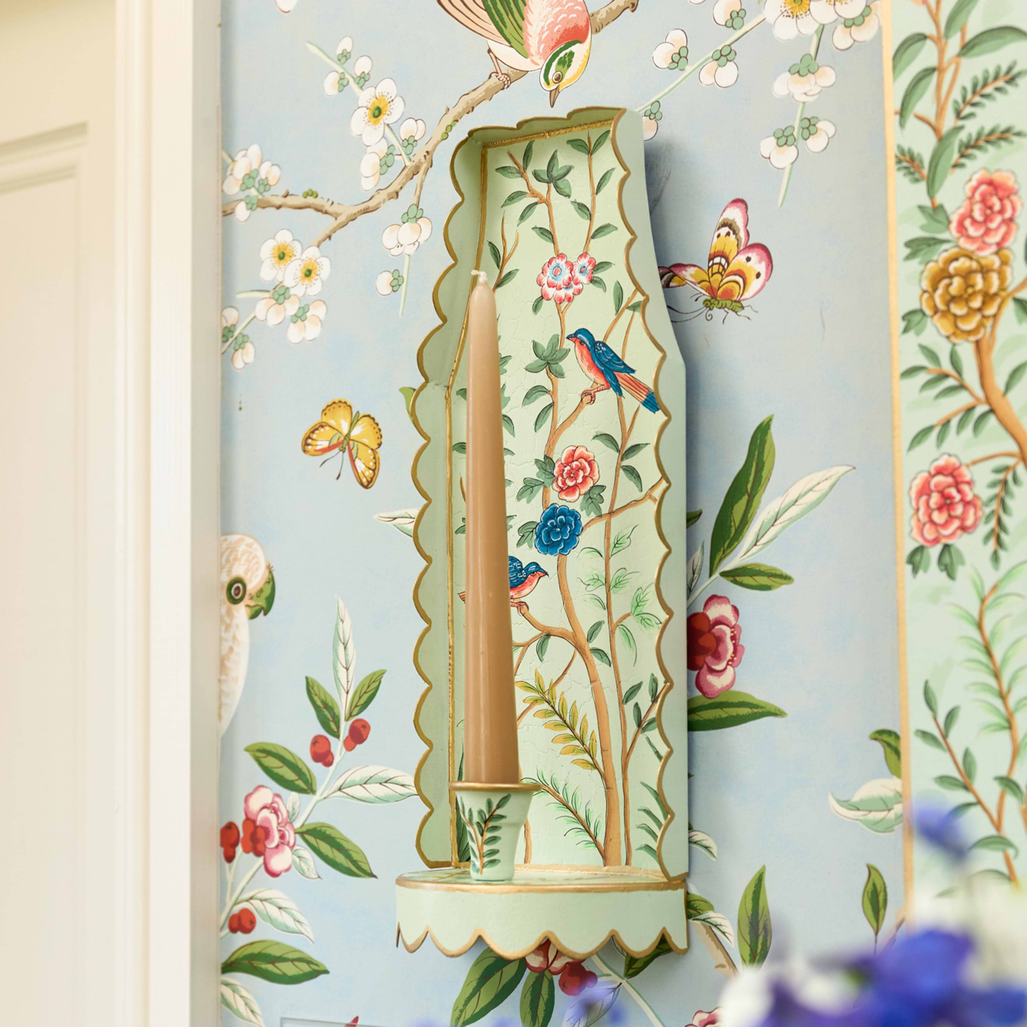 Decorative wall art with floral and bird patterns on a light blue background