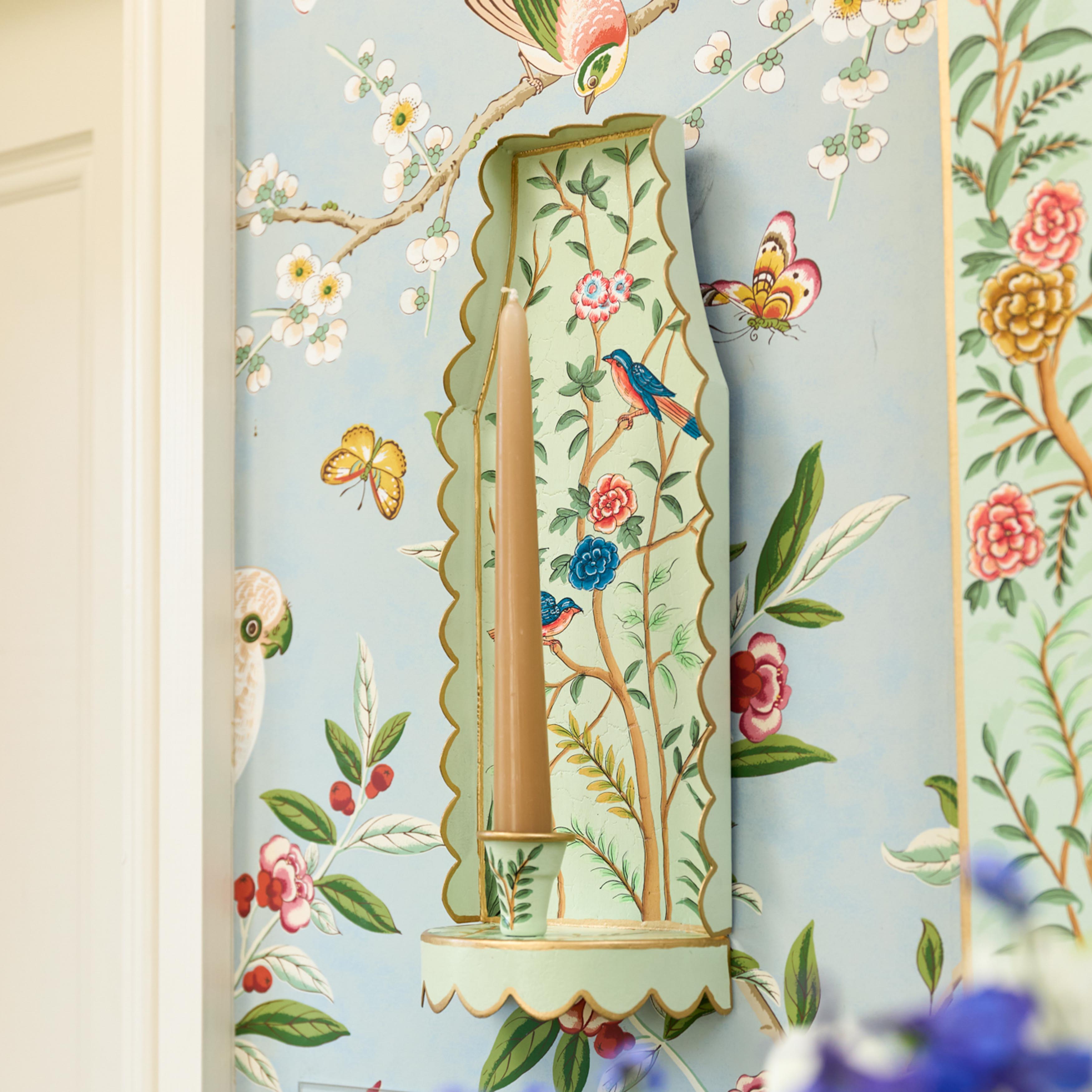 Decorative wall art with floral and bird patterns on a light blue background