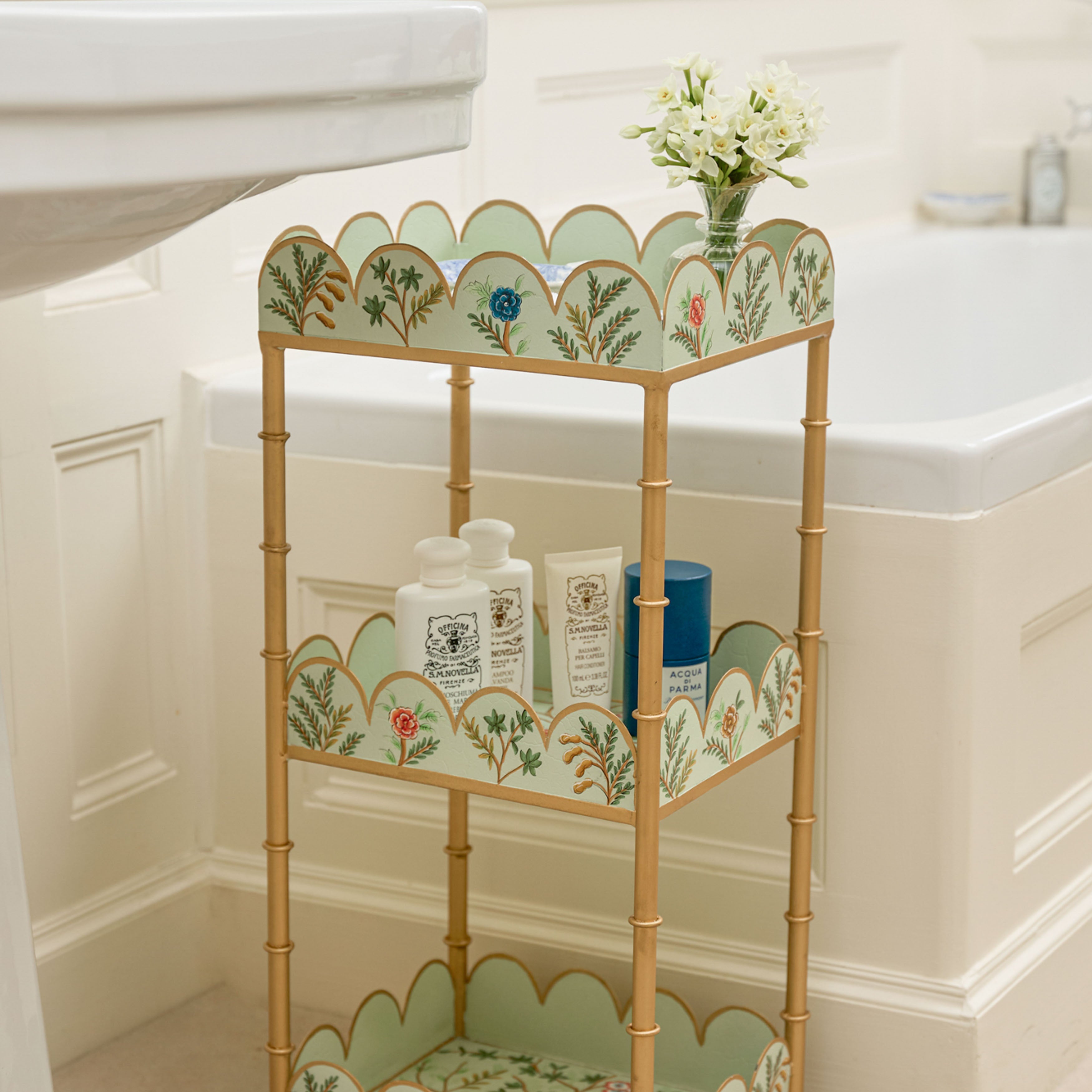 Decorative metal shelf with floral patterns in a bathroom setting