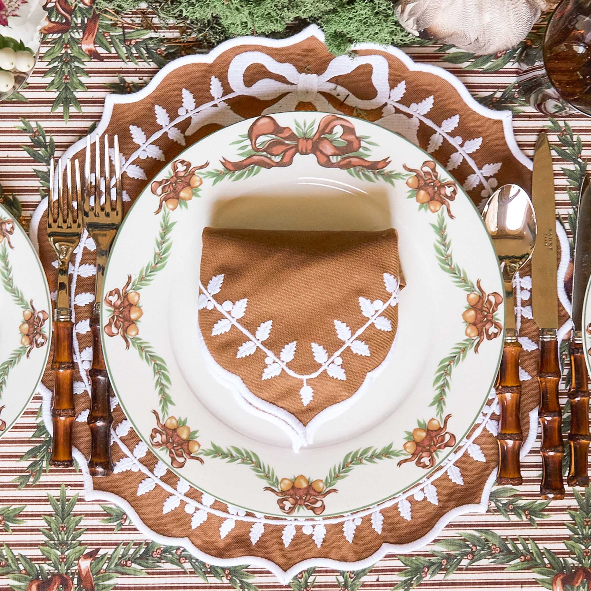 Decorative autumn table setting with a plate, napkin, and cutlery on Mrs Alice's  tablecloth.