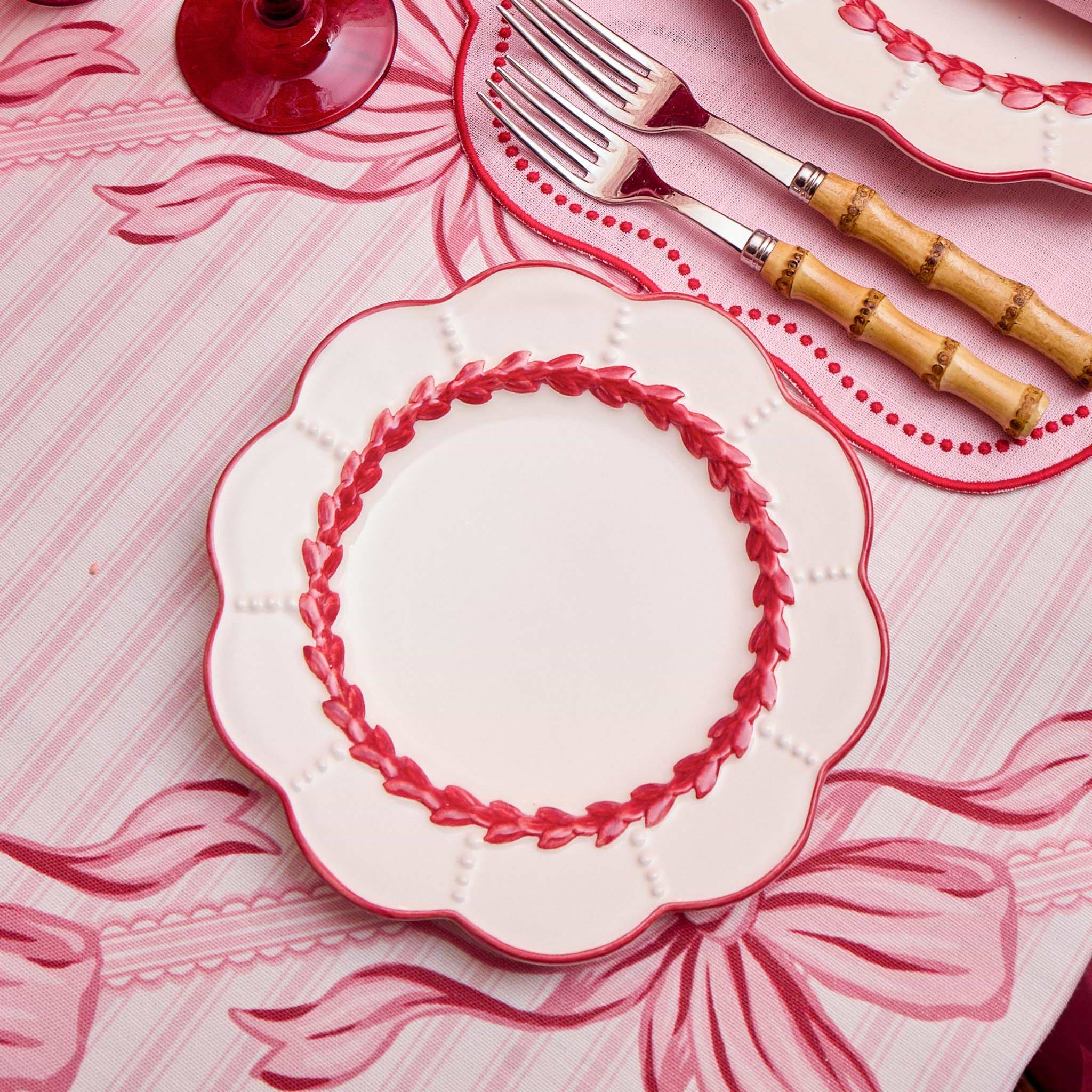 Decorative plates with red rims on a matching tablecloth