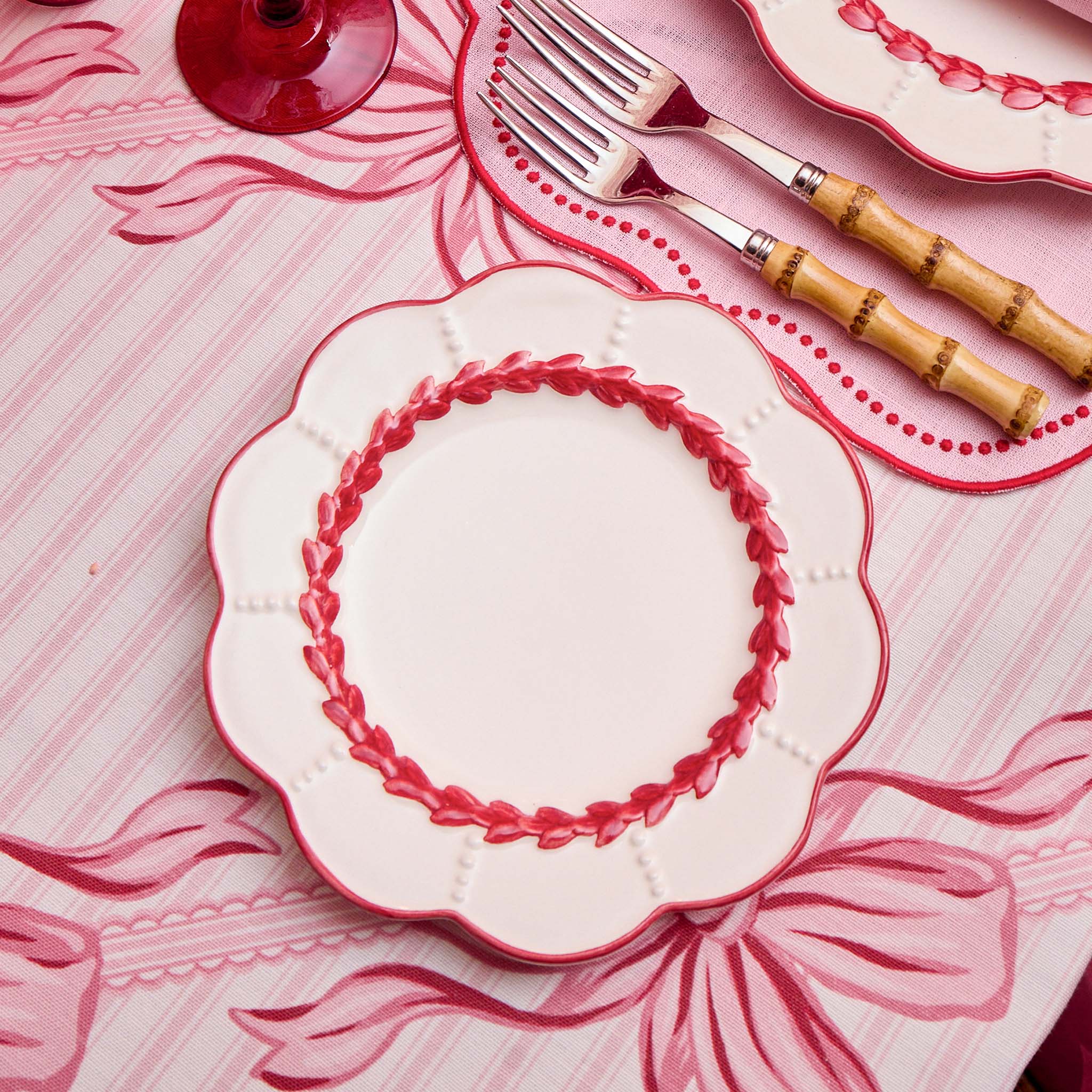 Decorative plates with red rims on a matching tablecloth