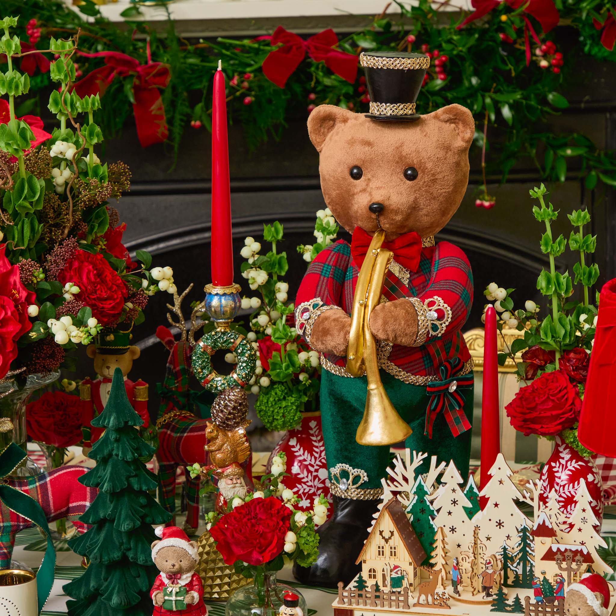 Decorative Christmas scene with a teddy bear playing a trumpet, surrounded by trees, flowers, and candles.