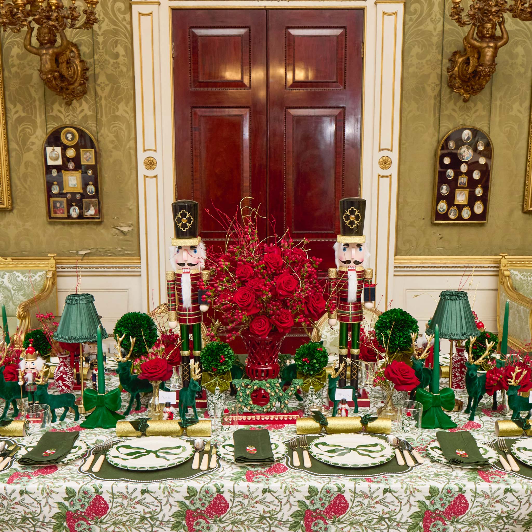 Decorative table setting with red and green theme in an elegant room.