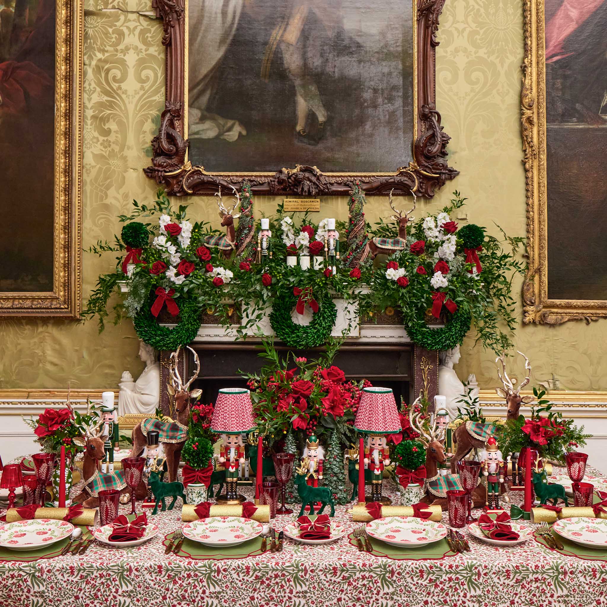 Decorative Christmas table setting with floral arrangements and nutcrackers in a formal room.