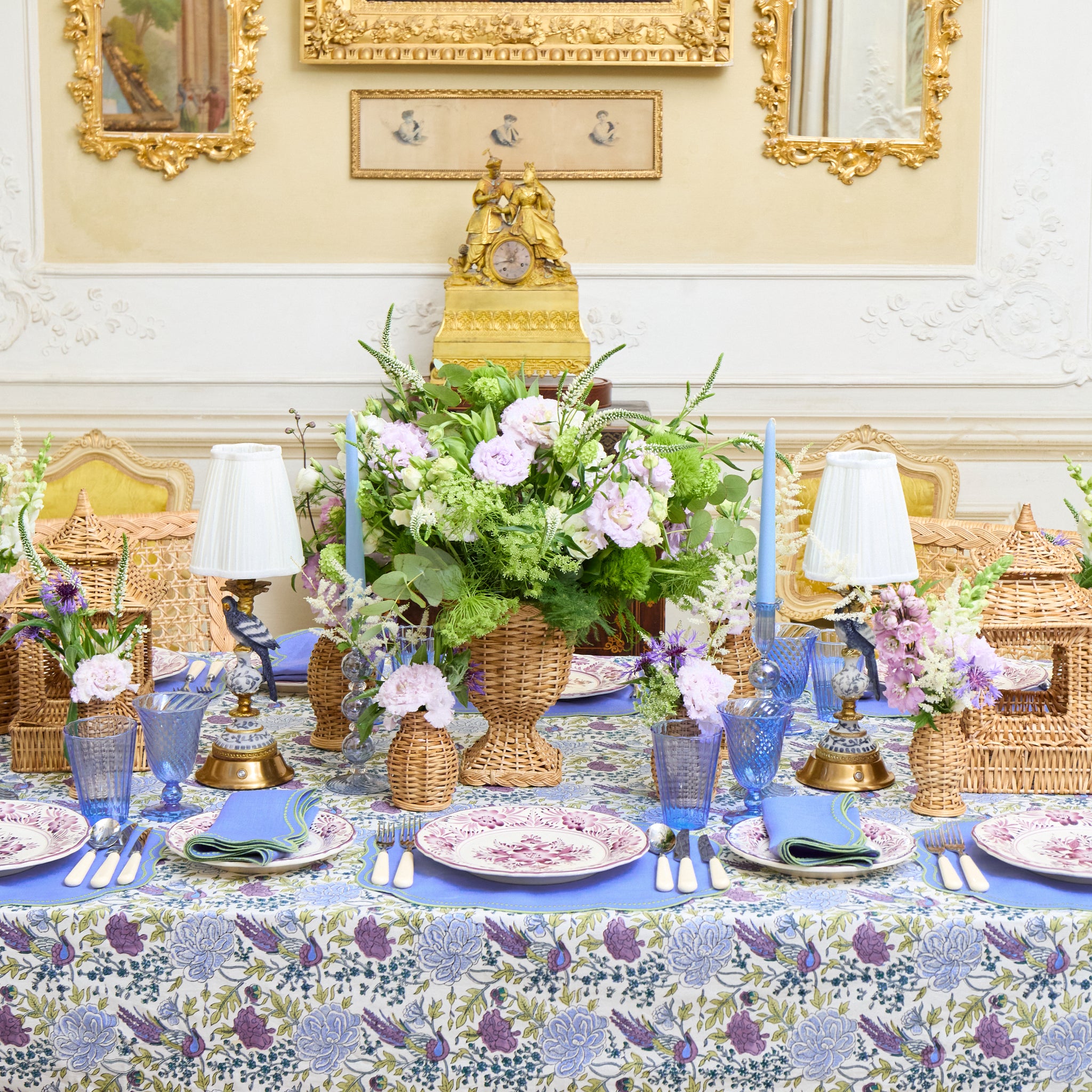 Elegant dining table setting with floral arrangements and decorative elements in a formal room.