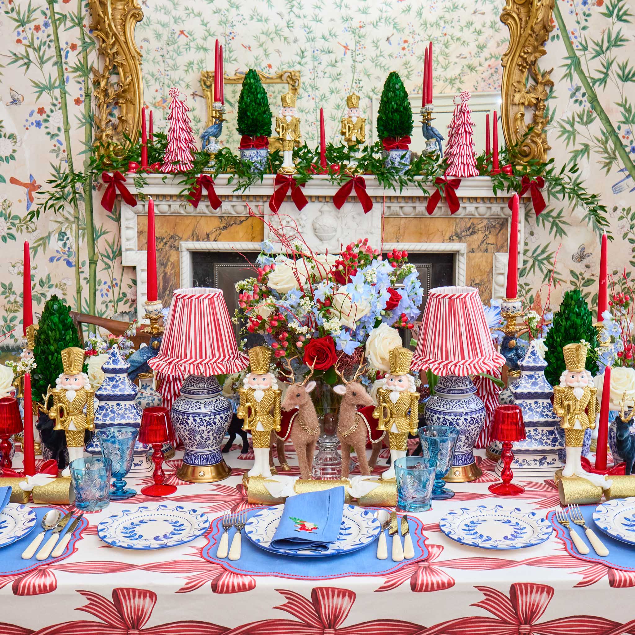 Decorative Christmas table setting with ornaments, candles, and floral arrangements.