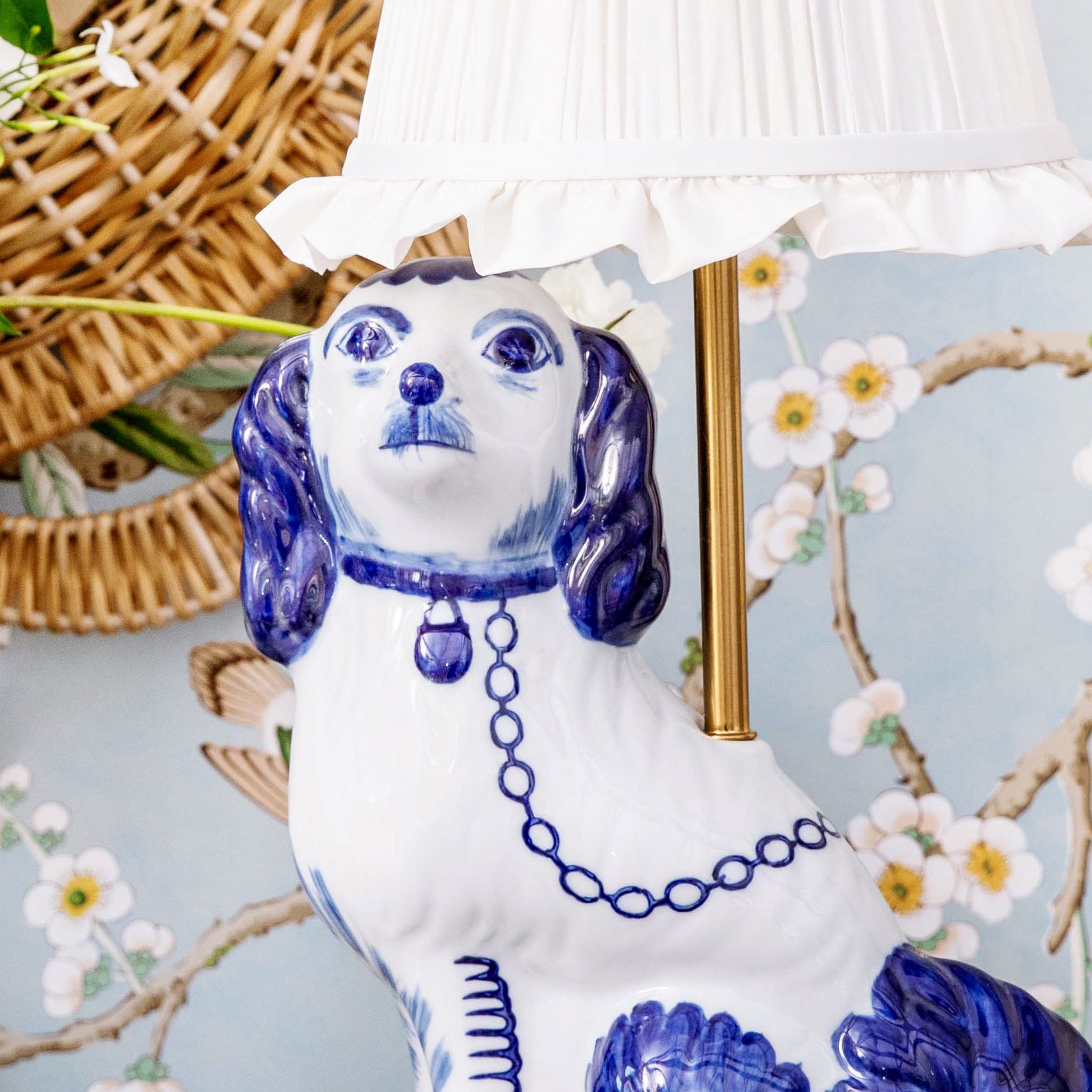 Decorative ceramic dog with blue and white pattern on a floral background