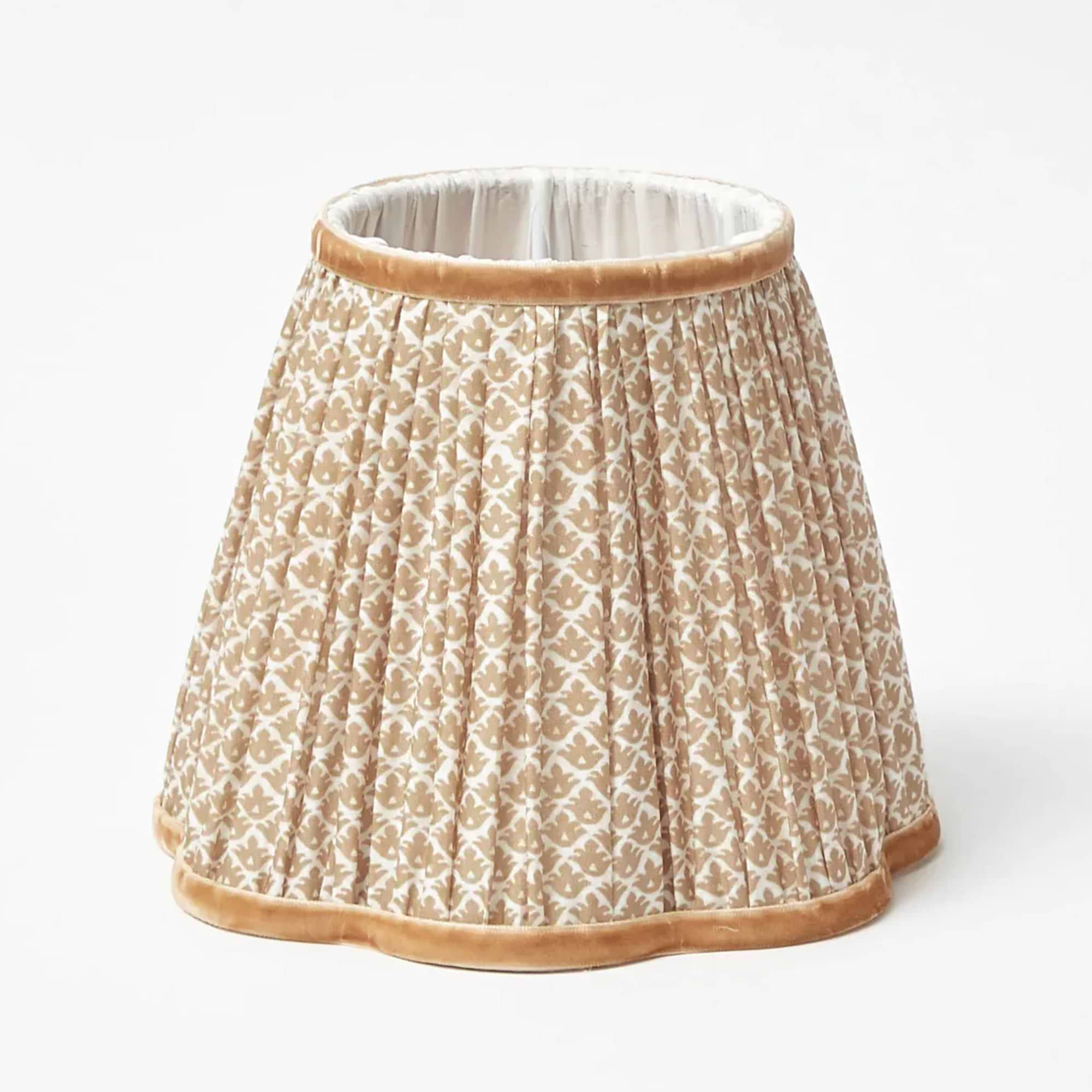 lotus patterned lampshade with brown trim on a white background