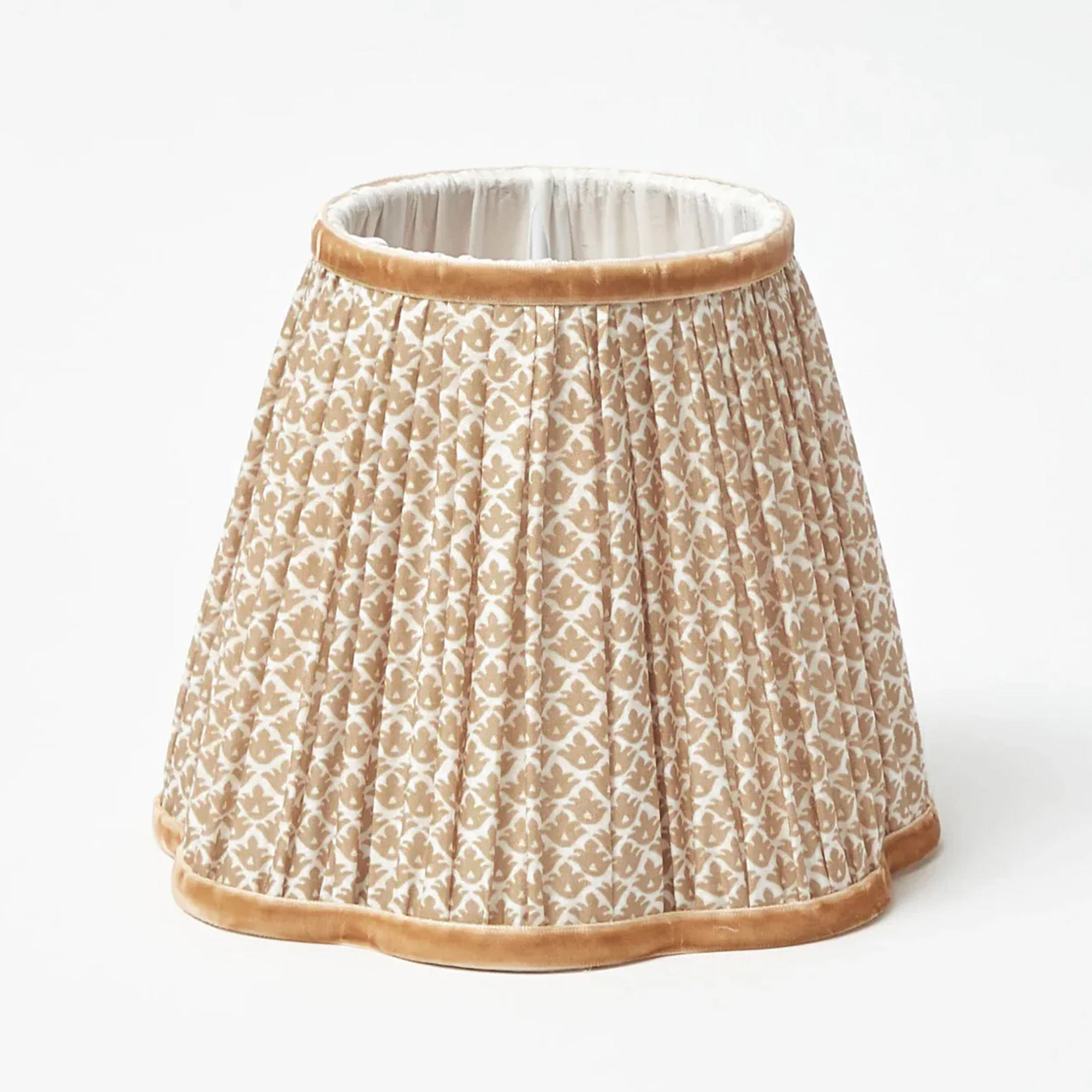 lotus patterned lampshade with brown trim on a white background