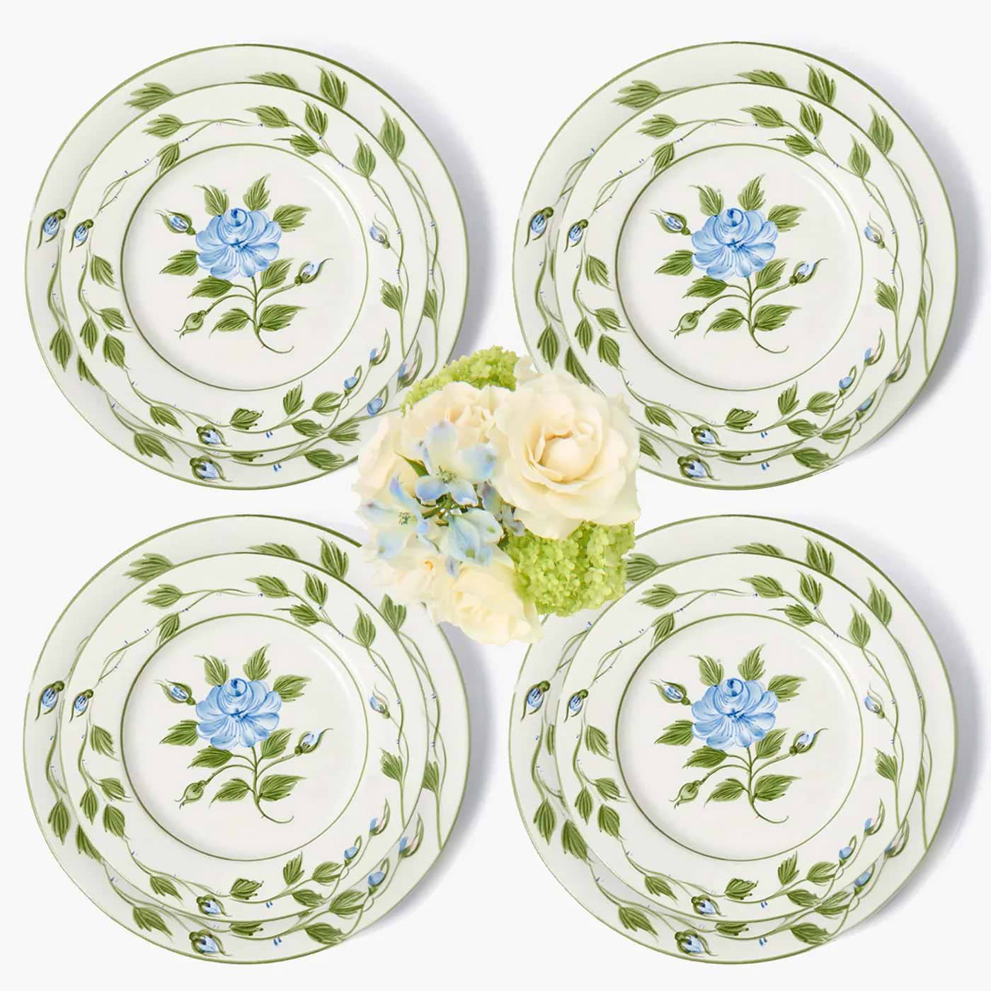 Set of four ceramic plates with floral design on a white background