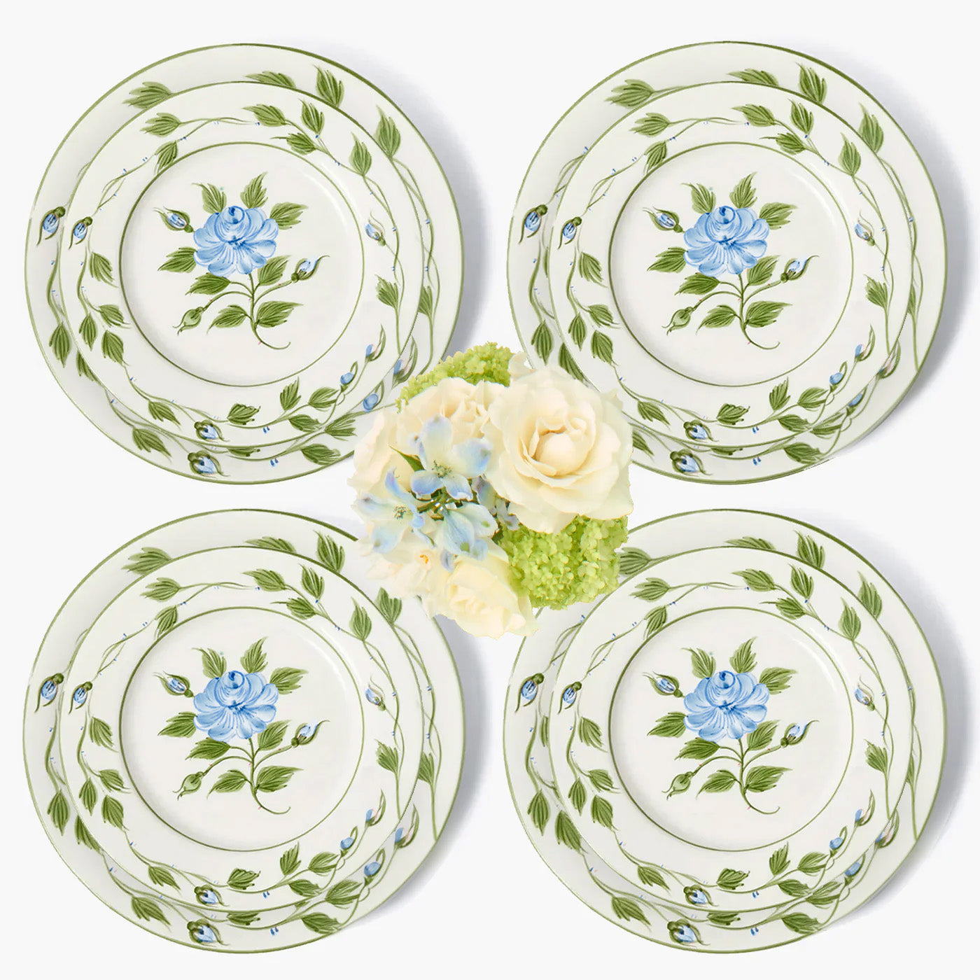 Set of four ceramic plates with floral design on a white background
