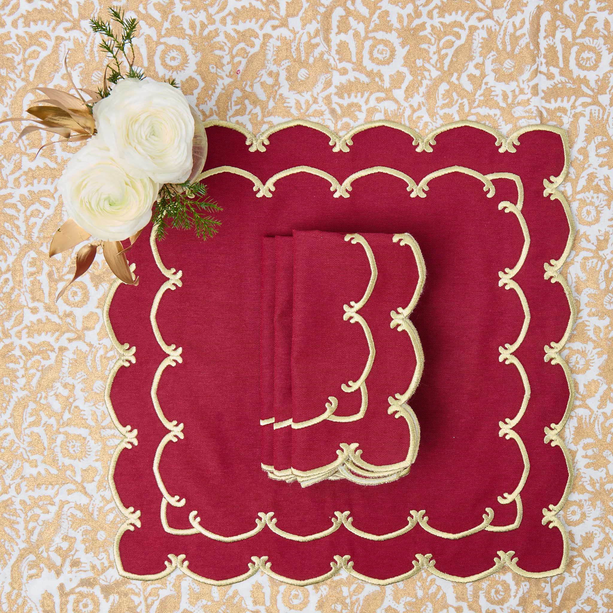 Red placemat with gold embroidery on a decorative background