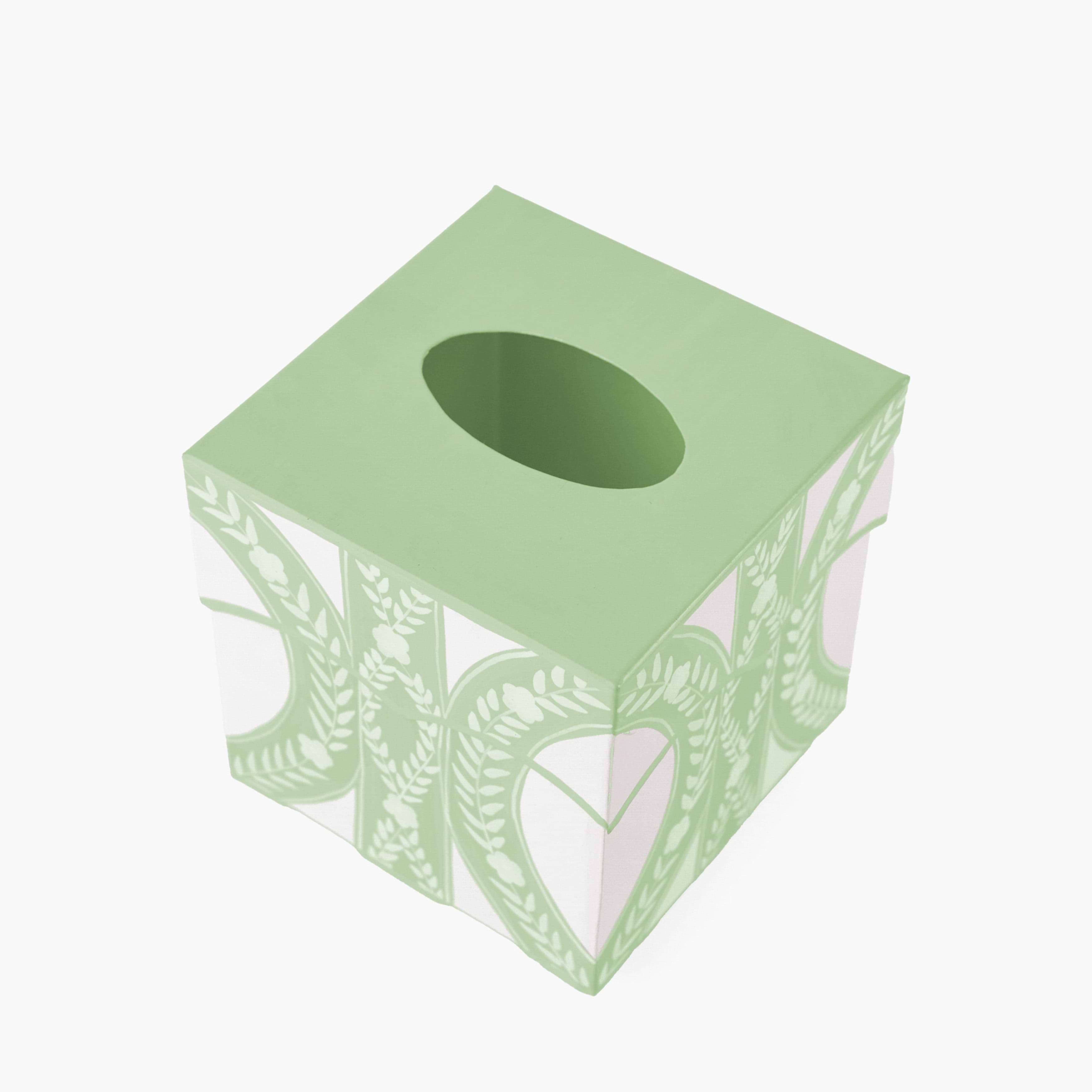 Green tissue box with leaf pattern on a white background