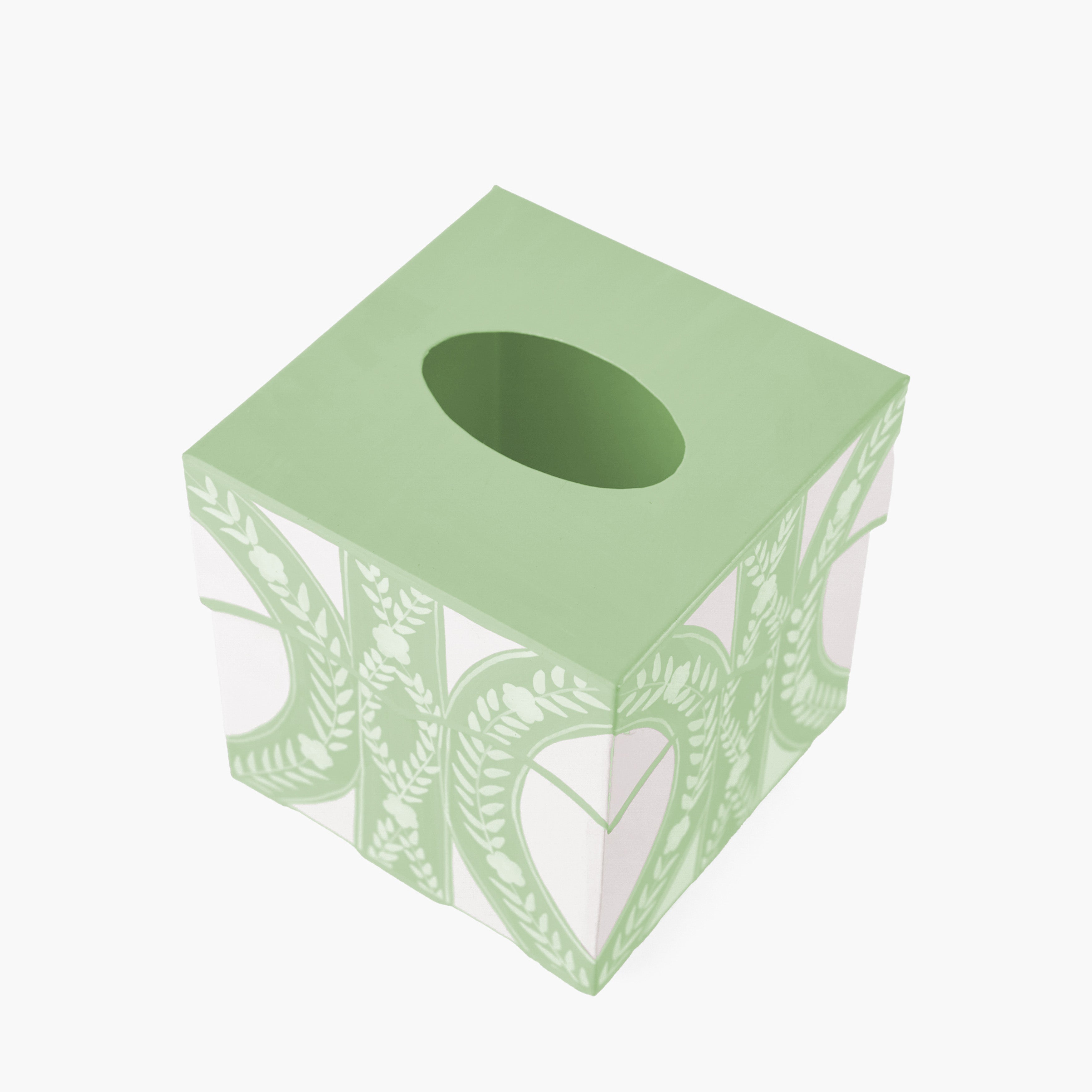 Green tissue box with leaf pattern on a white background