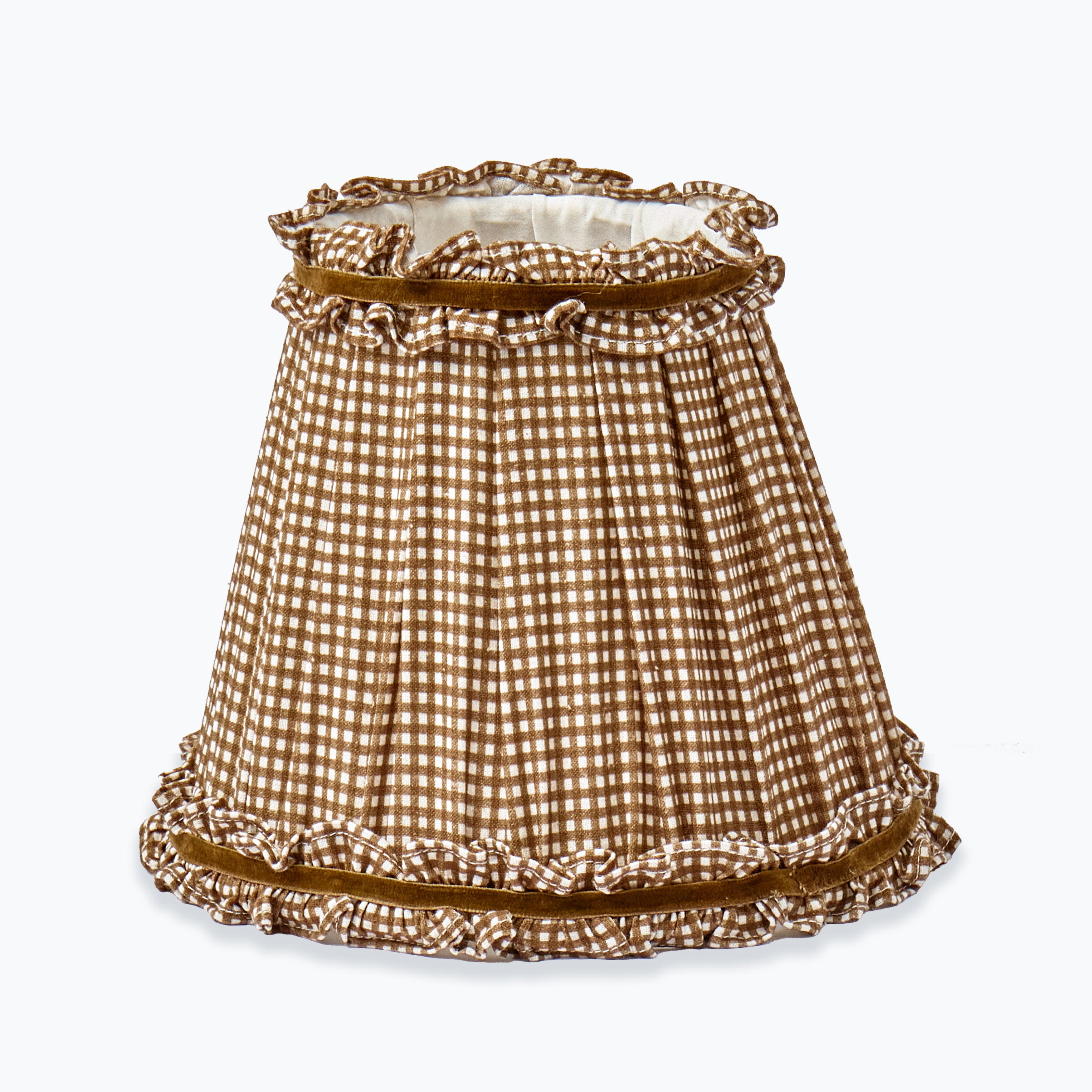 A pleated fabric lampshade with a brown and white gingham check pattern, featuring ruffled trim at the top and bottom on a light gray background.
