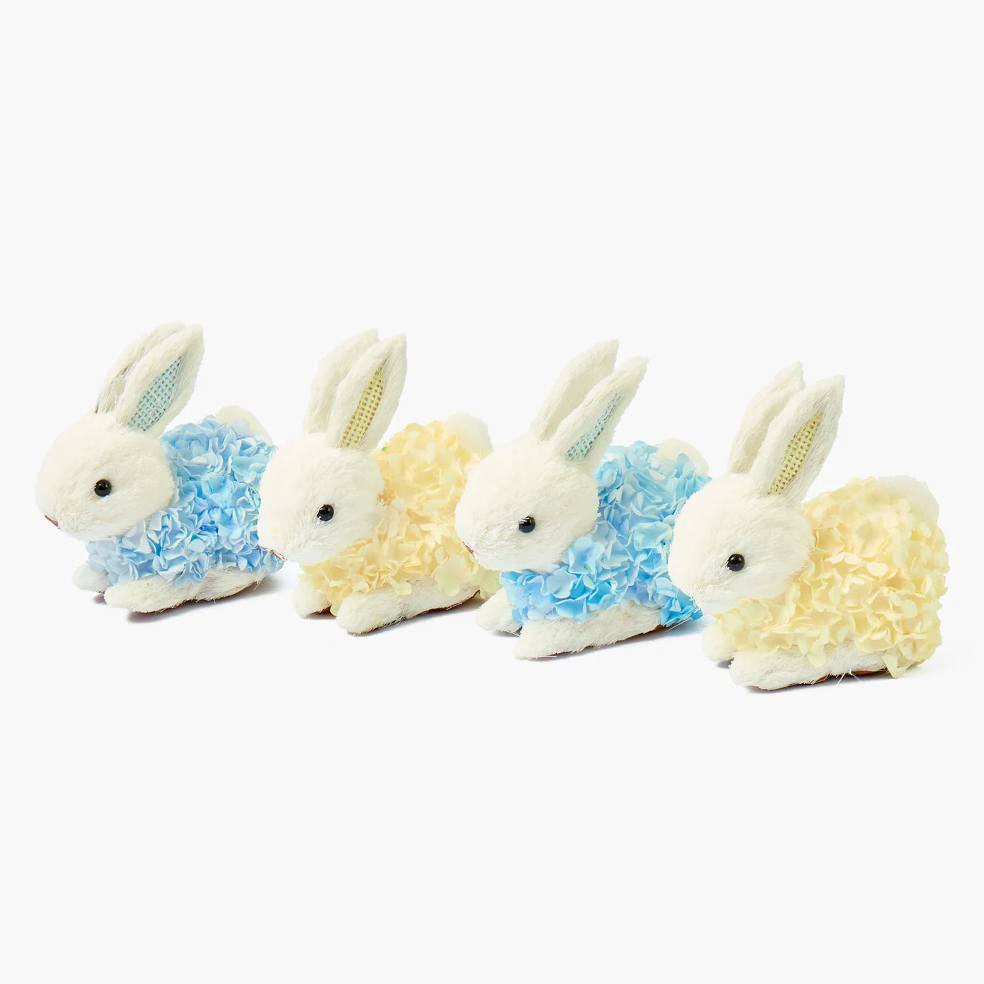 Four plush bunny toys with floral patterns on a white background