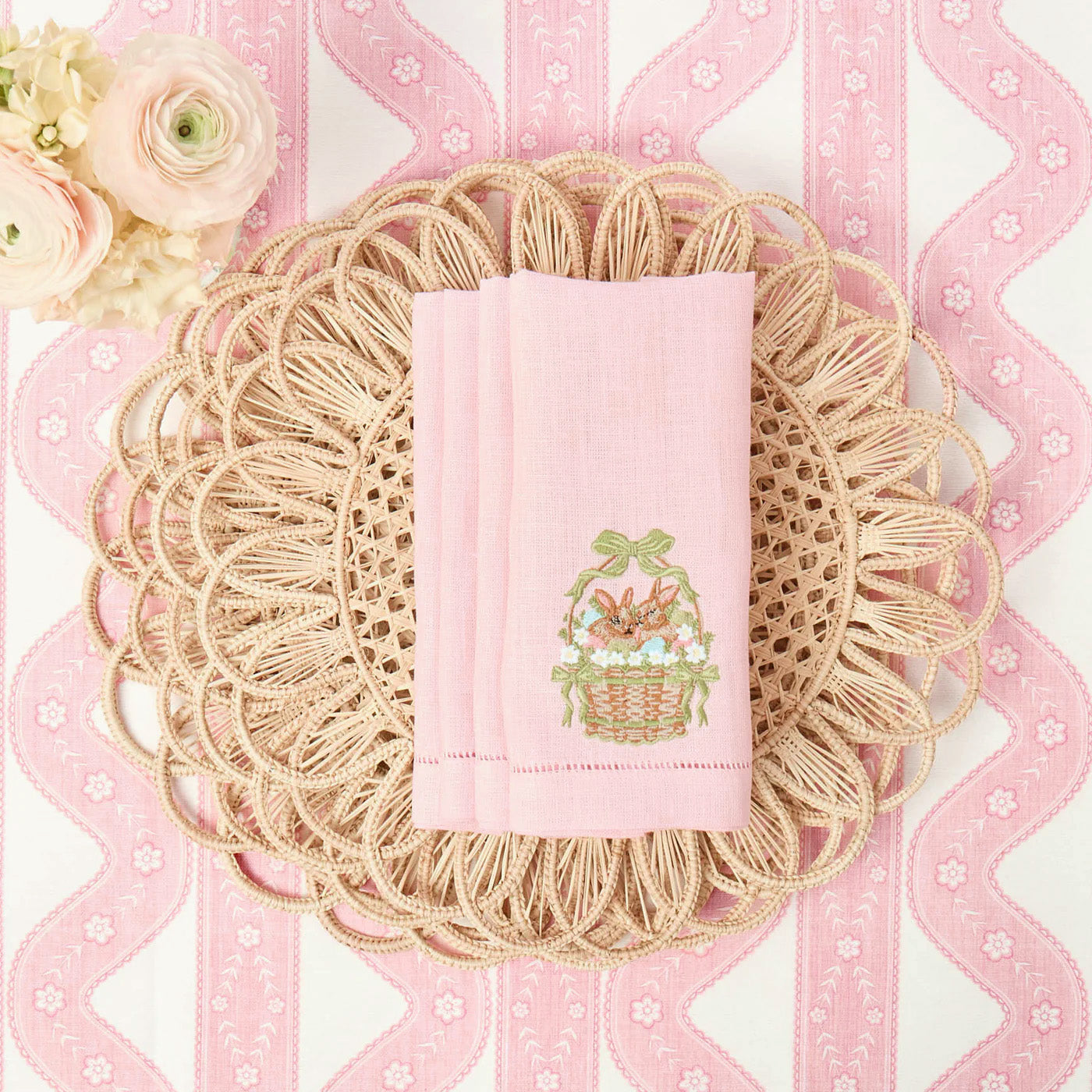 Decorative pink towel with a basket design on a textured pink background