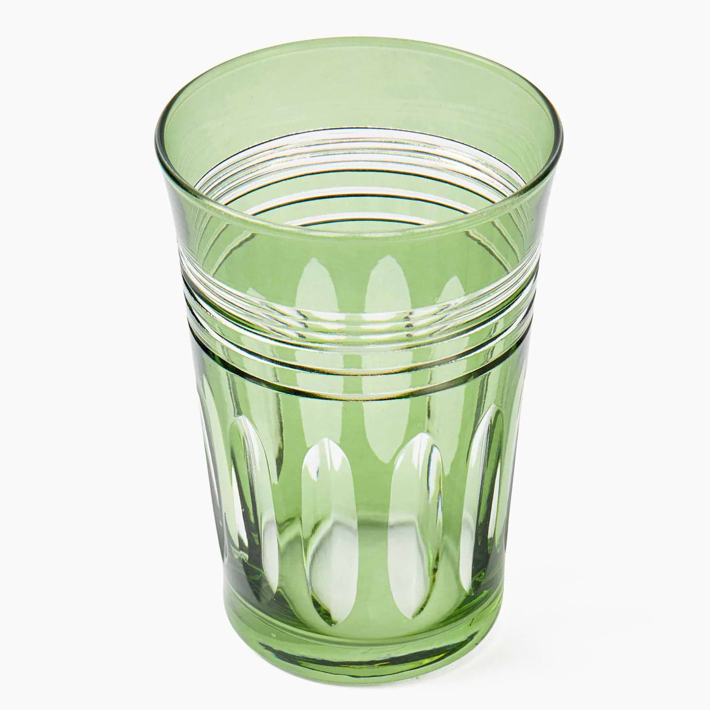 Green glass tumbler with a white background