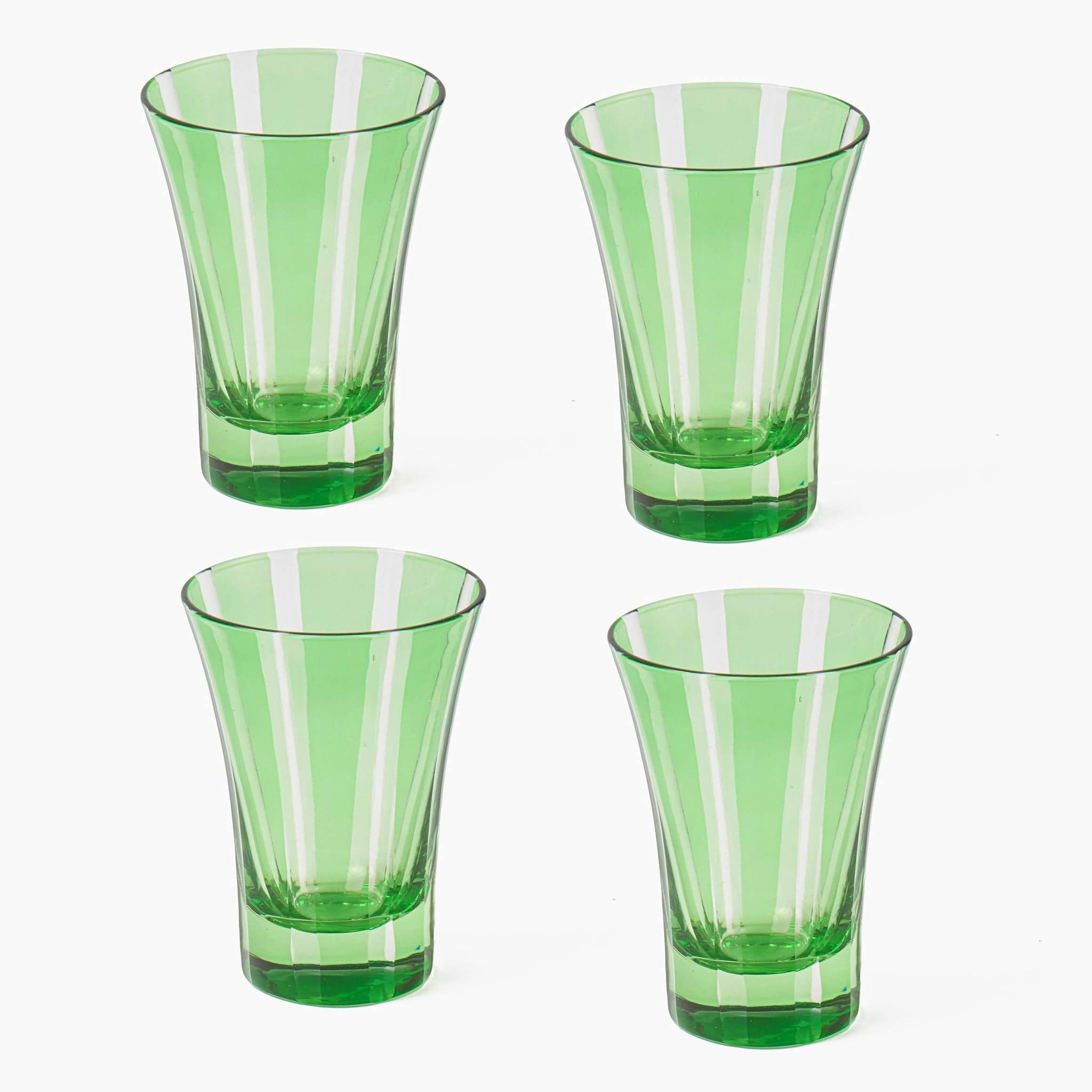 Four green glass tumblers with striped design on a white background