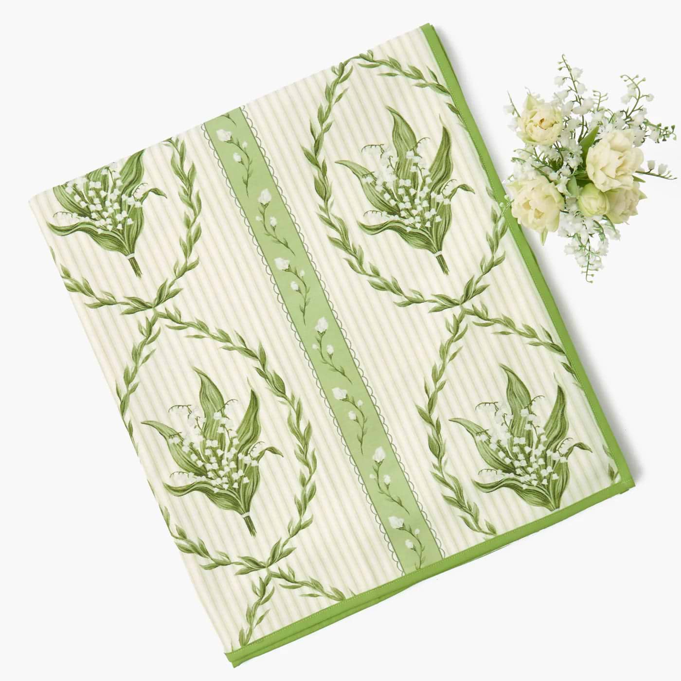 Green and white patterned towel with floral design on a white background