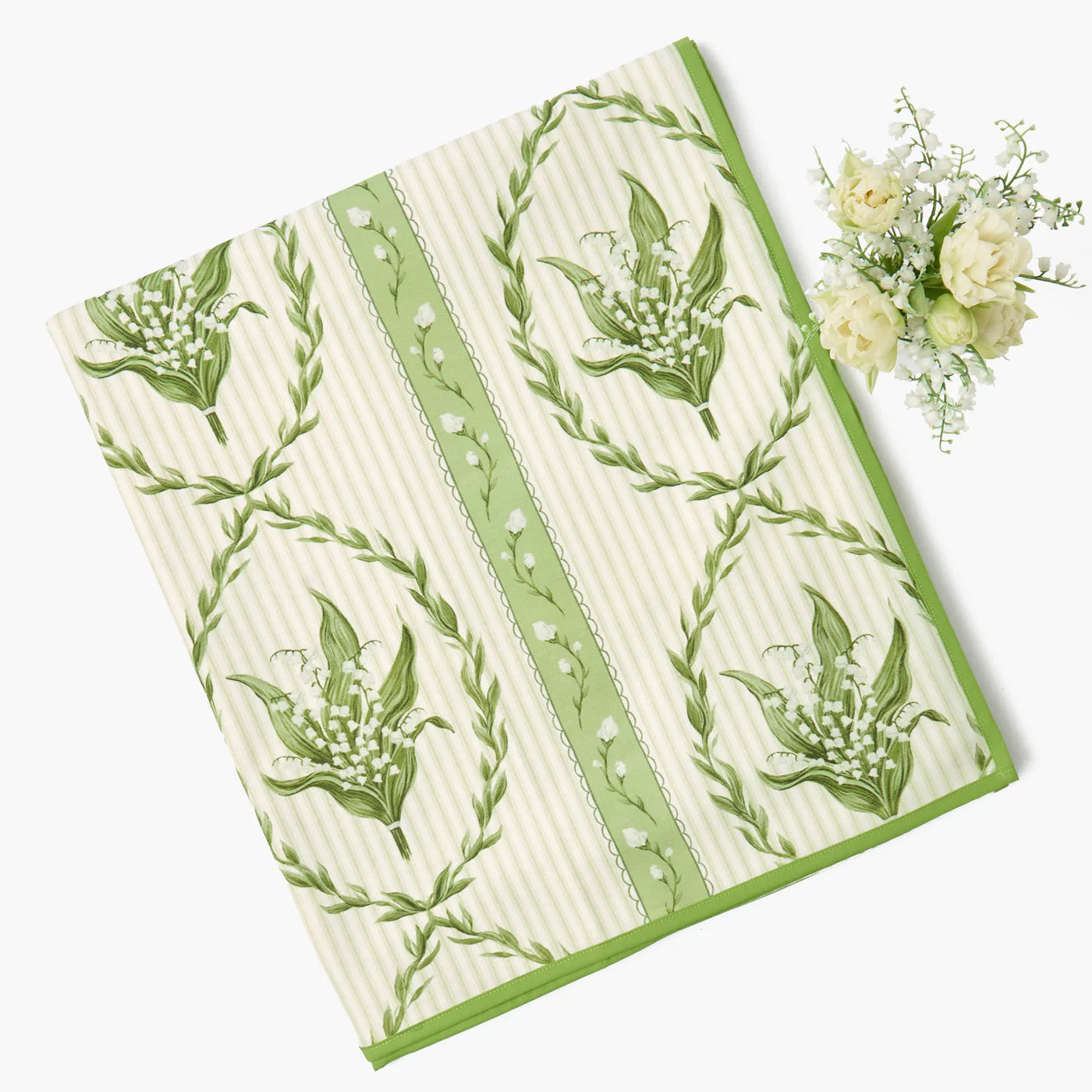 Green and white patterned towel with floral design on a white background