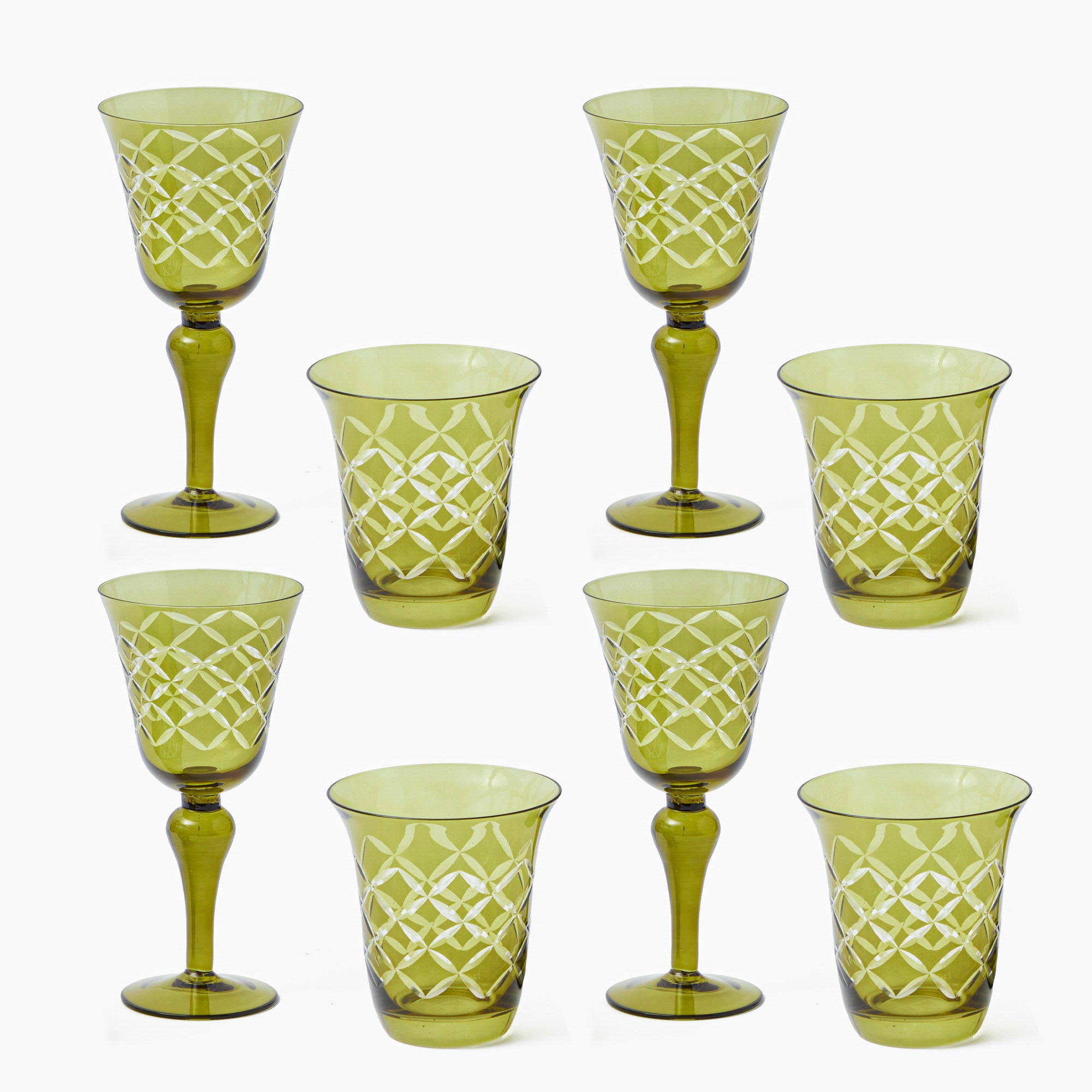 Set of green patterned glass tumblers on a white background