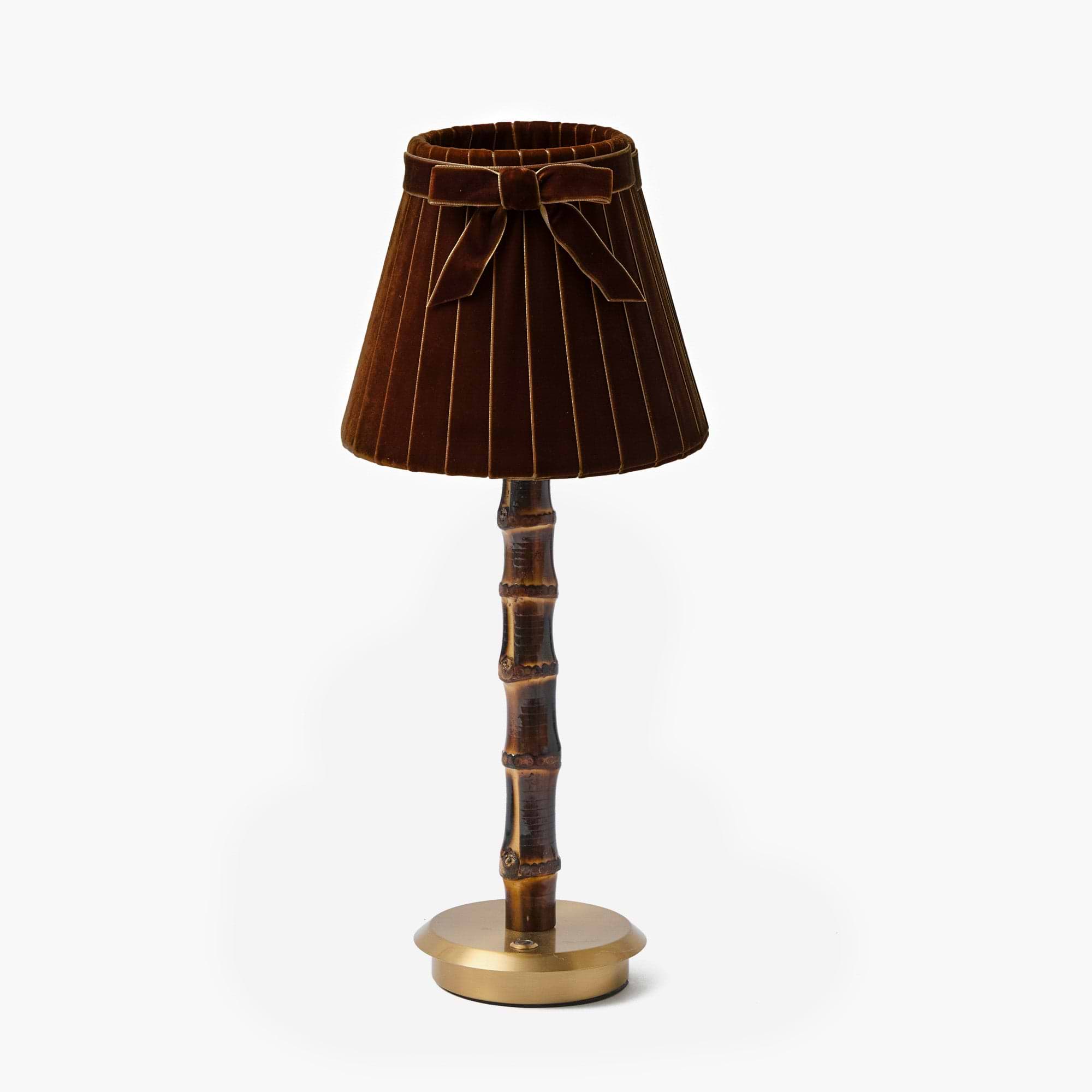 Decorative lamp with brown pleated shade and bamboo-like base on a white background