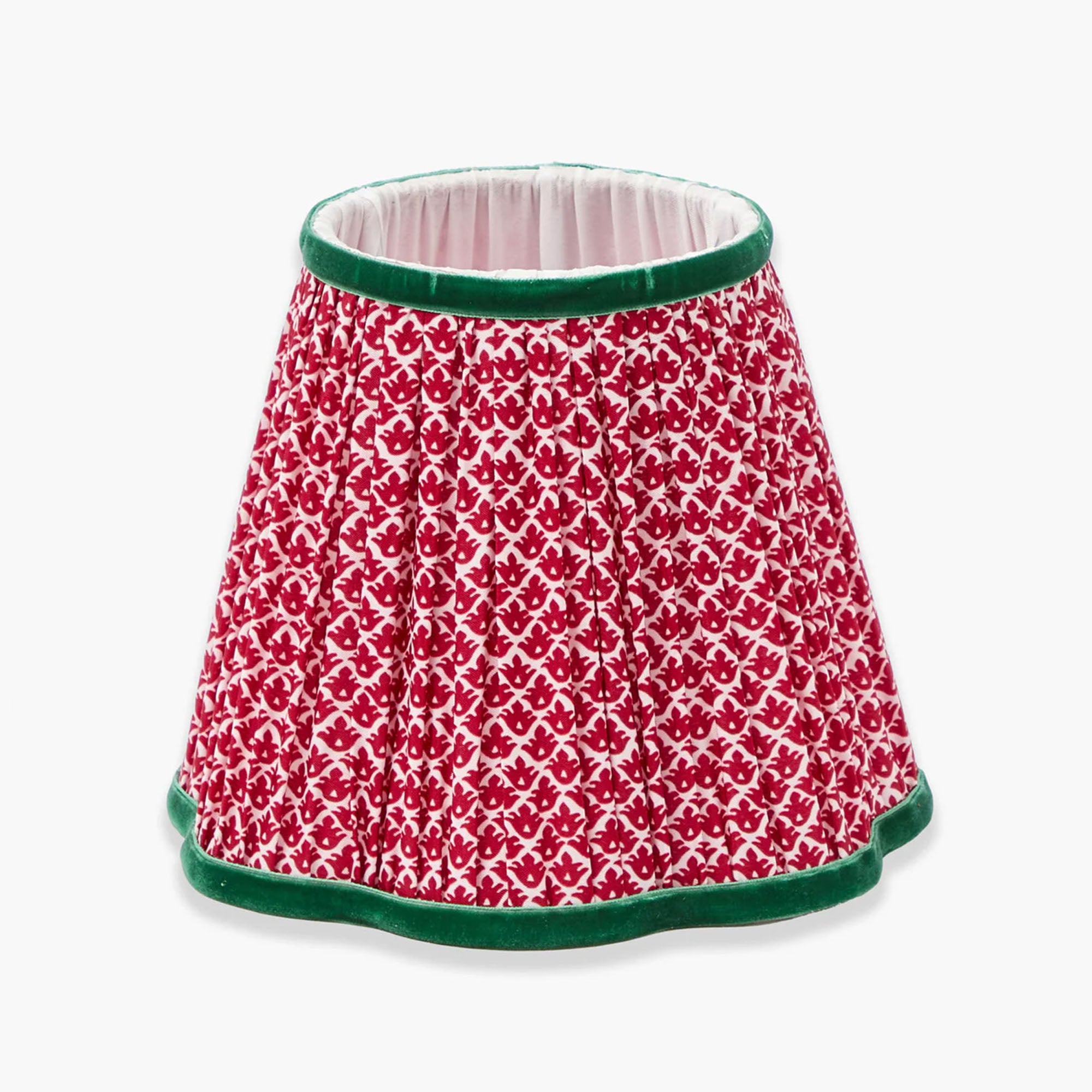Red and white lotus patterned lampshade with green trim on a white background